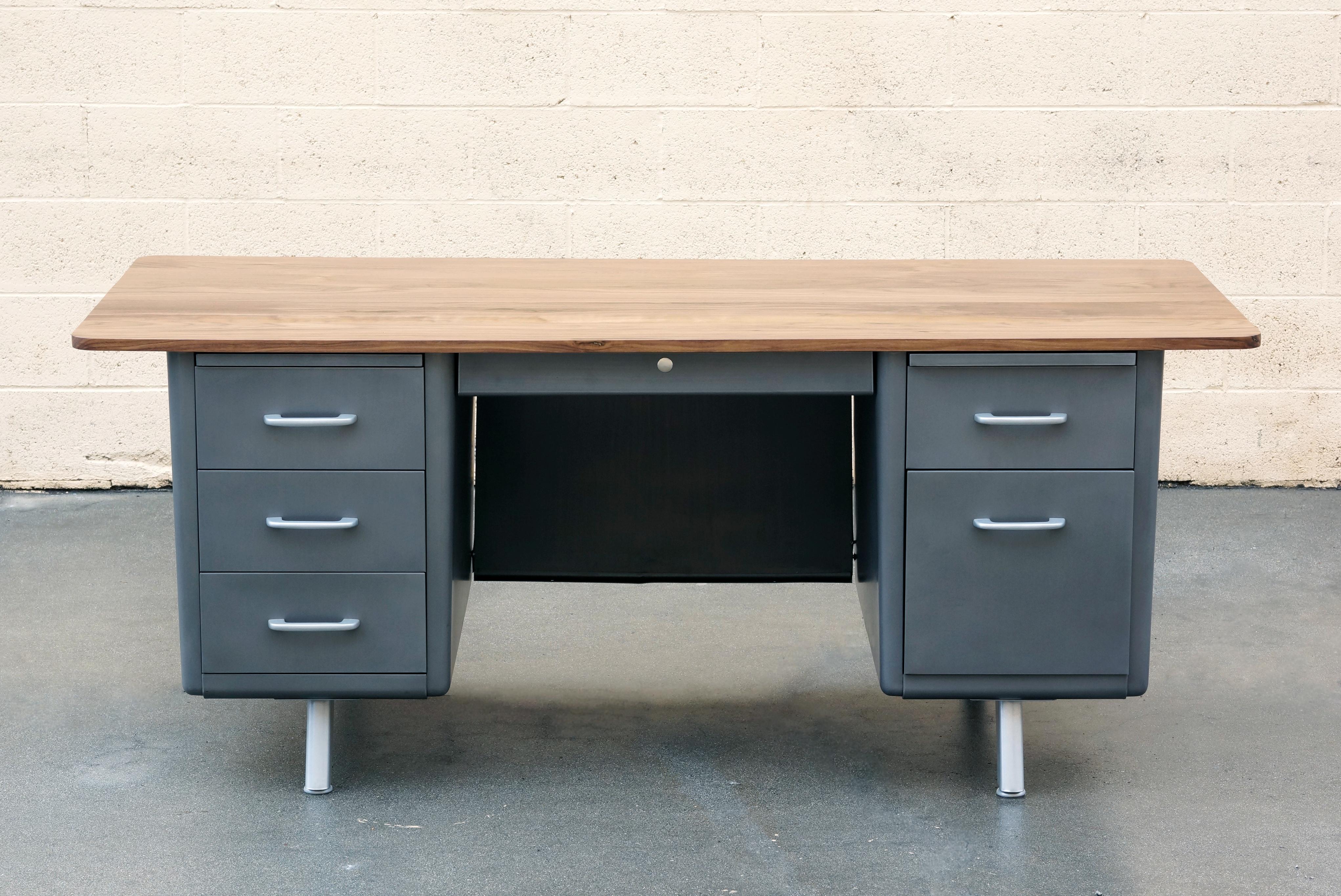 Midcentury steel tanker desk refinished with a twist. This beauty features an oversized solid walnut top with radius corners and a 