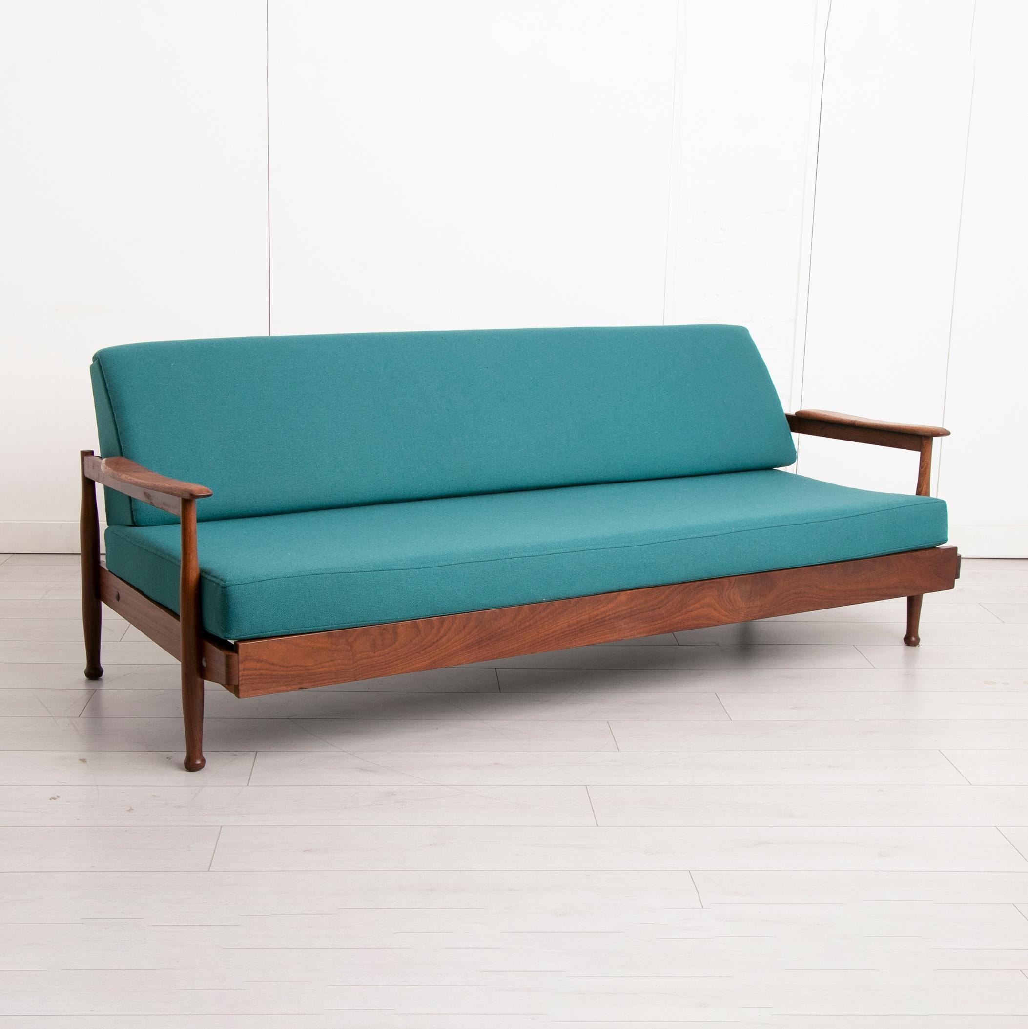 A mid century teak and afrormosia day bed by Guy Rogers newly reupholstered in teal fabric.

Dimensions: 201 W x 90 D x 76 H cm
Seat height: 41 cm.