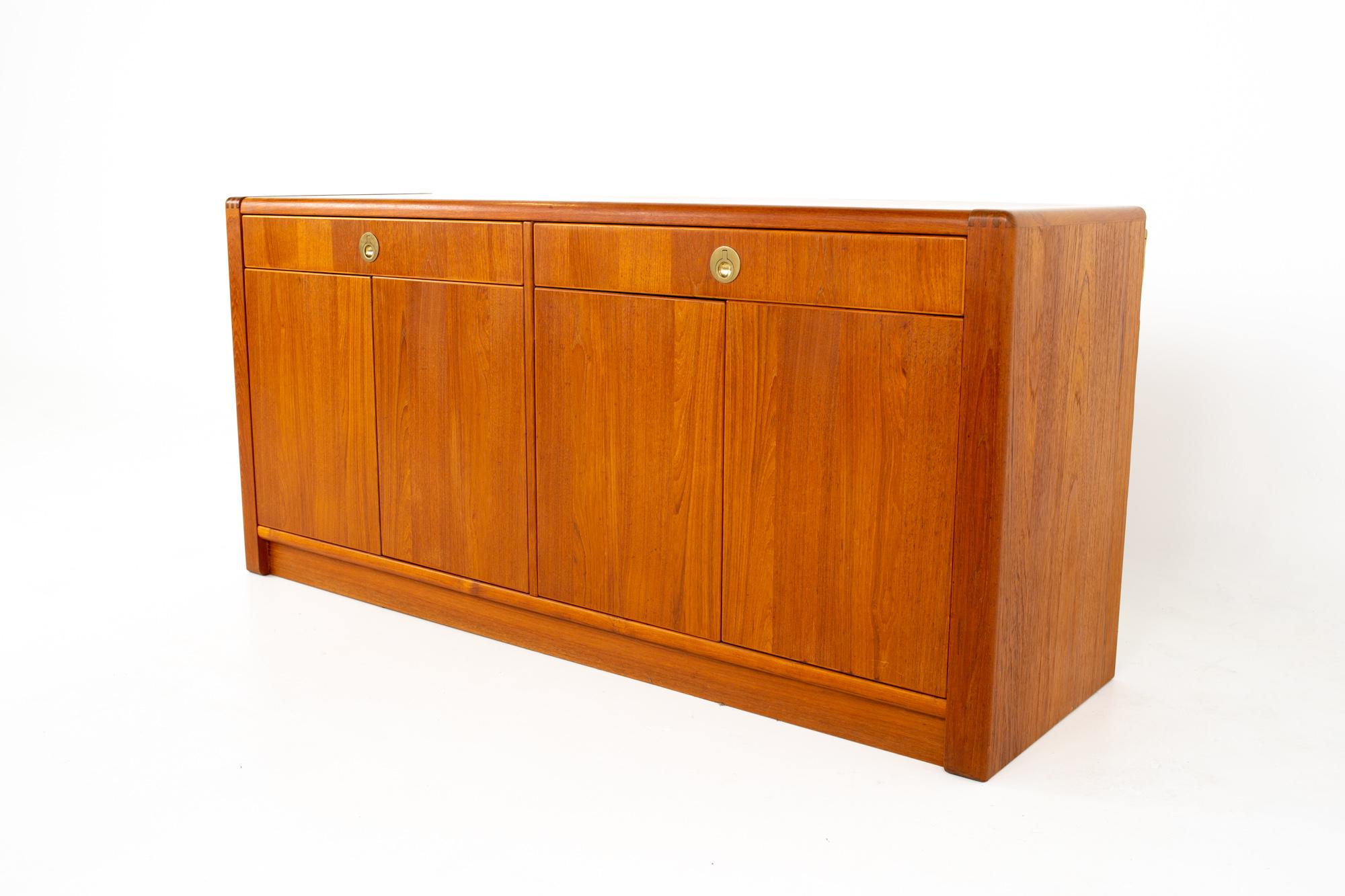 Mid Century teak and brass sideboard buffet credenza
Credenza measures: 62.75 wide x 19.75 deep x 29.5 high

All pieces of furniture can be had in what we call restored vintage condition. That means the piece is restored upon purchase so it’s free