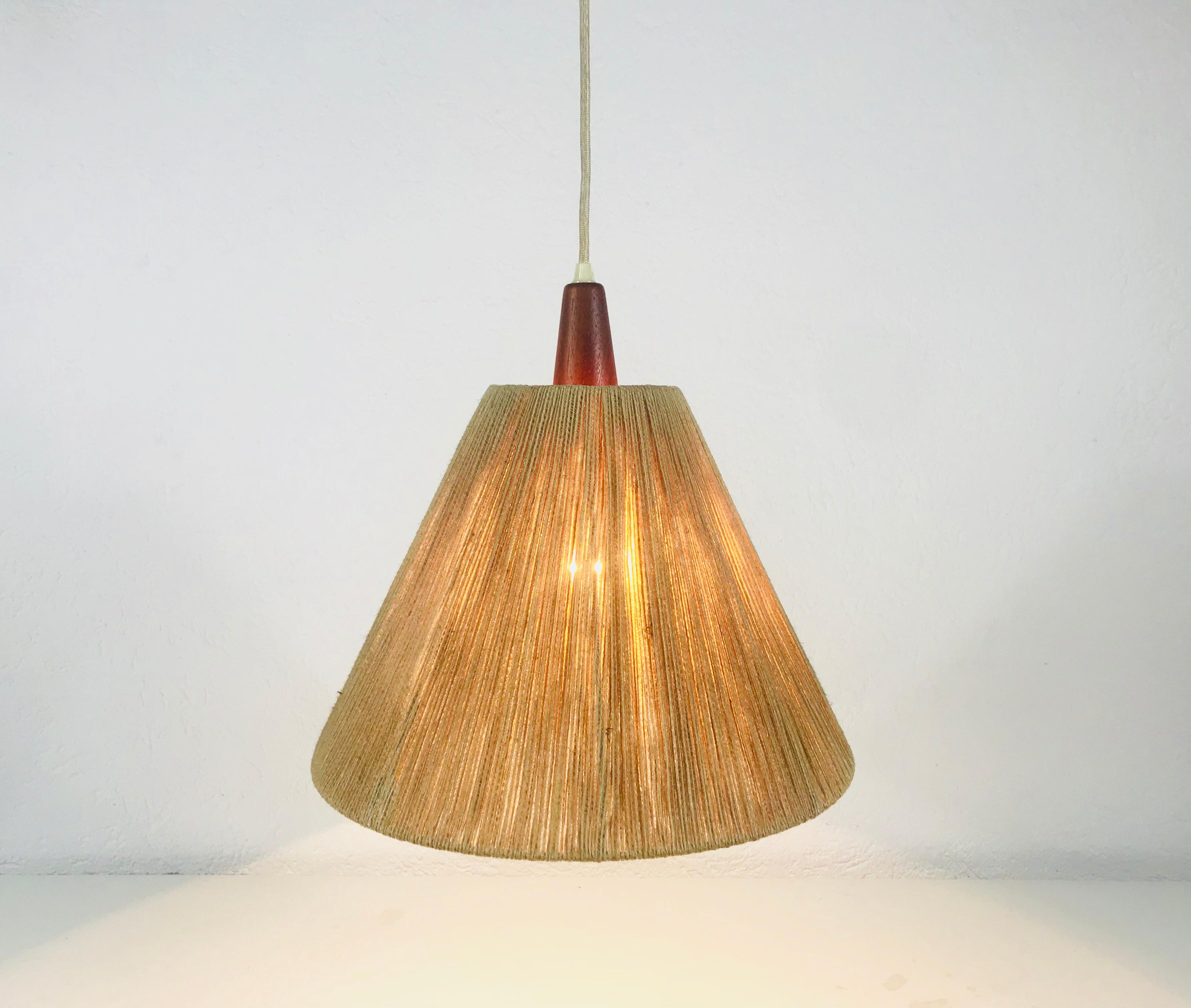 A wonderful Scandinavian teak hanging lamp made in the 1960s. It is fascinating with its rare cone lamp shade. The rope of the lamp is also height adjustable. The height is min 50 cm and max 150 cm. 


The light requires one E27 light bulb.