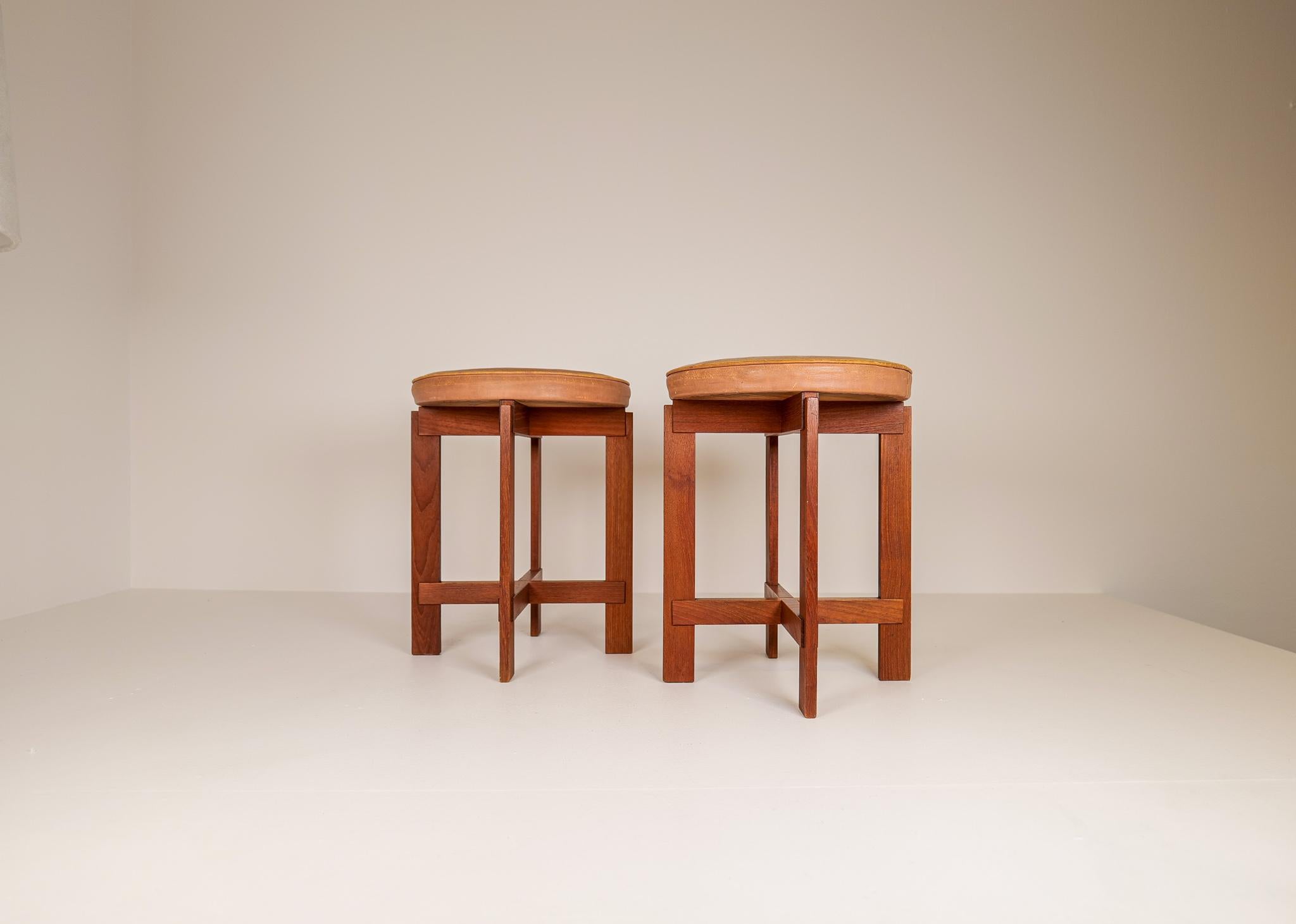 These stools in teak with seats in leather was designed by Uno & Östen Kristiansson for Luxus, Sweden.
The teak part is in excellent condition. The seats have a vintage wear and one of them more wear than the other.

The leather part can be