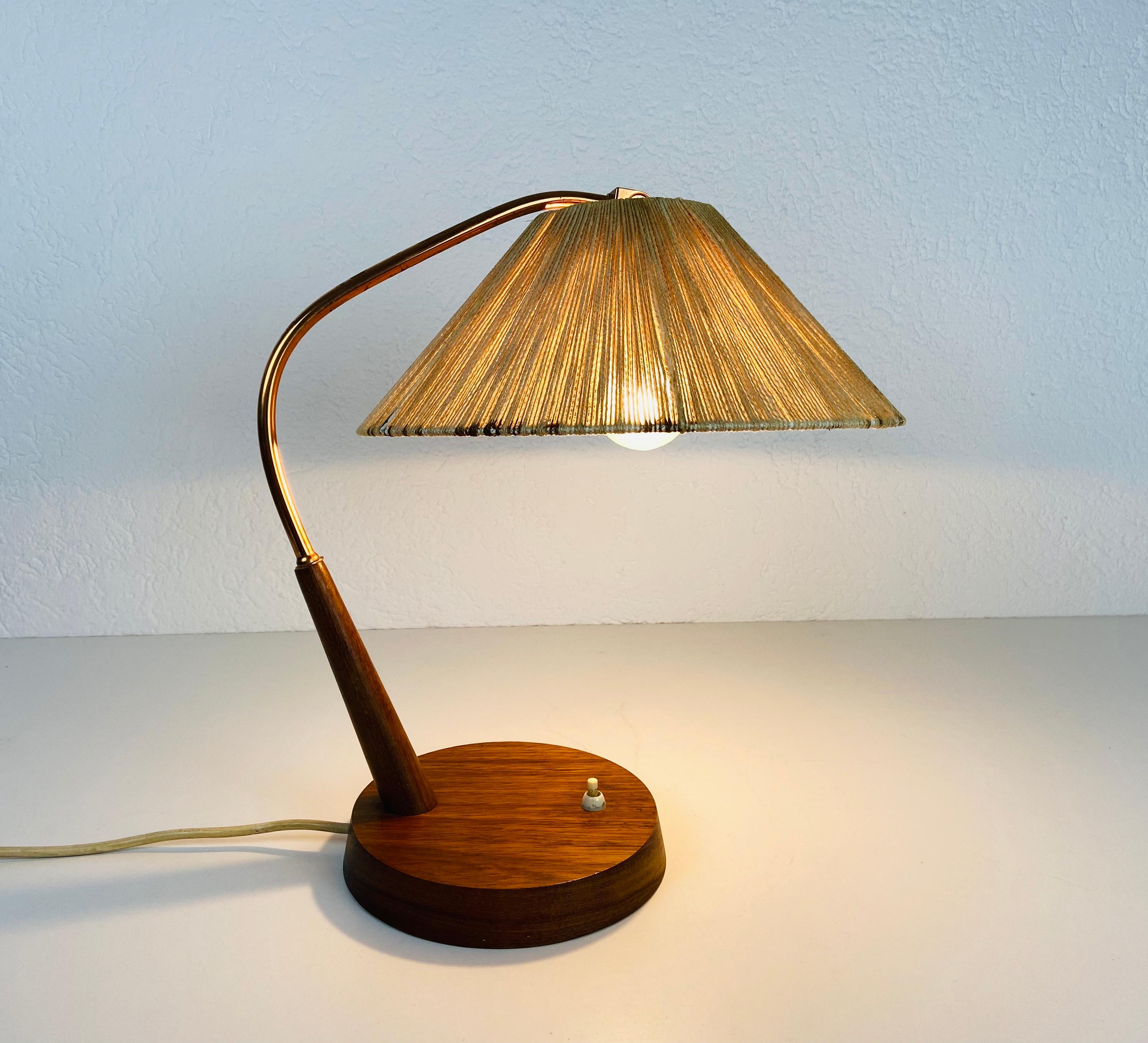 A wonderful teak table lamp made in the 1960s by Temde in Switzerland. It is fascinating with its rare lamp shade.

The light requires one E27 (US E26) light bulb. Good vintage condition.

Free worldwide express shipping.