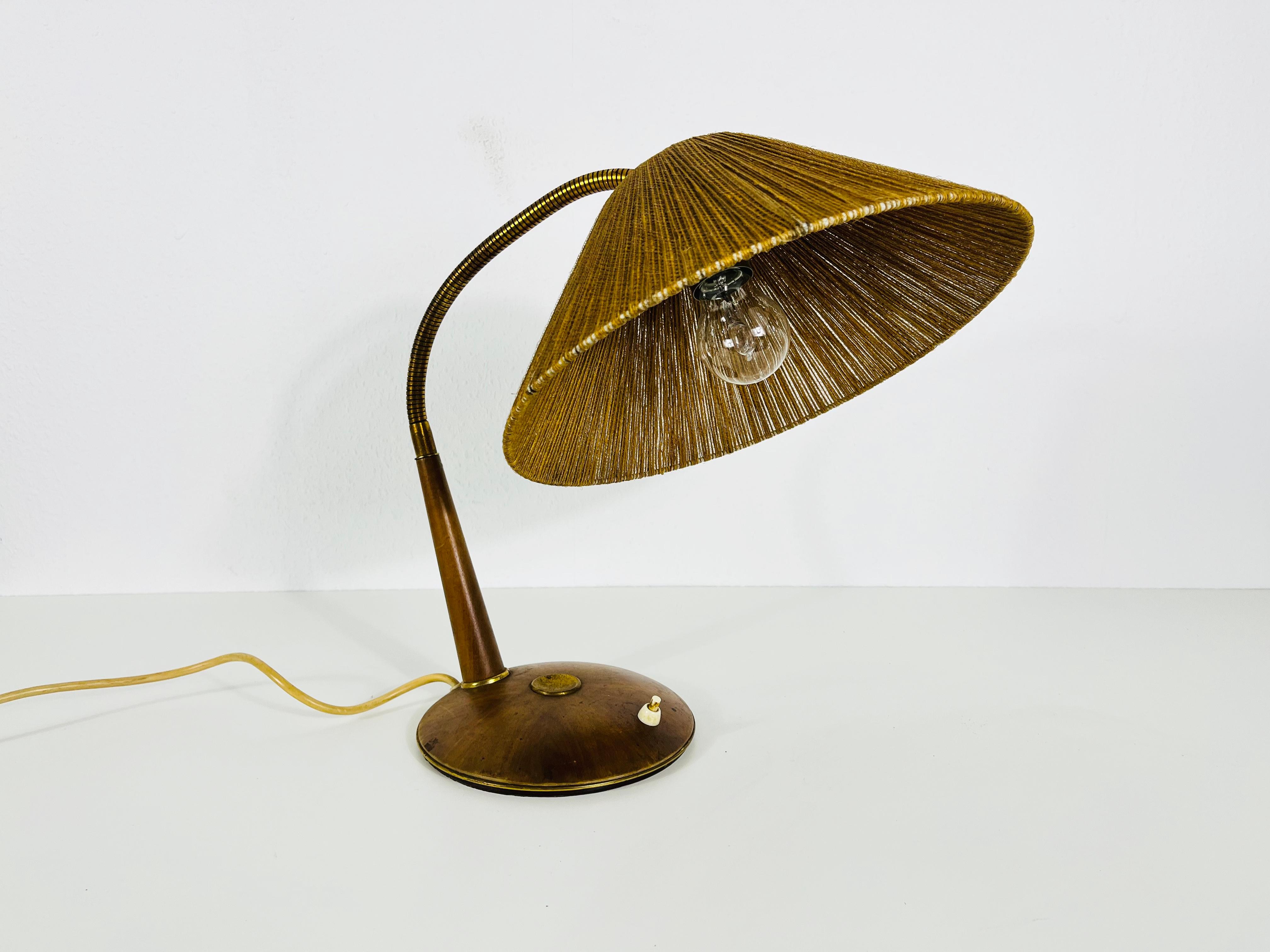 A wonderful teak table lamp made in the 1960s by Temde in Switzerland. It is fascinating with its rare lamp shade.

Measures:

Height: max height: 70 cm
Shade dia: 32 cm
Base dia: 20 cm

The light requires one E27 (US E26) light bulb. Good