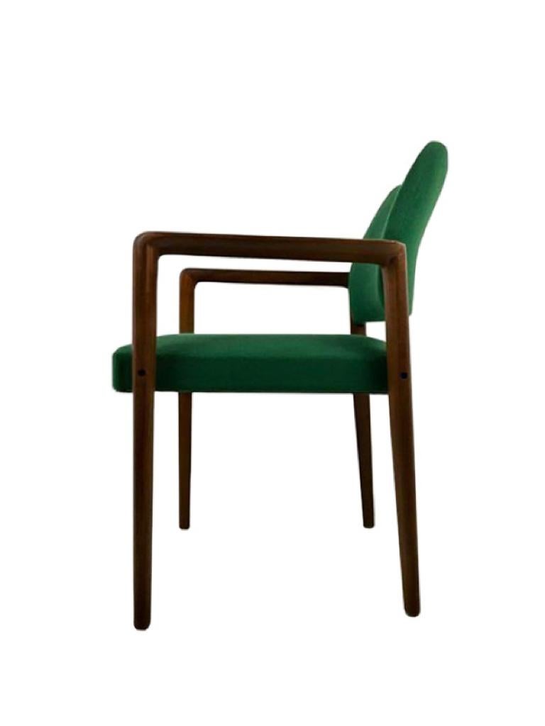 This set of two easy armchairs with a modernist silhouette was designed, circa 1970 and manufactured by Wilkhahn in Germany. The structure is made of teak wood and the original, well-preserved upholstery is in a deep green color. Due to its
