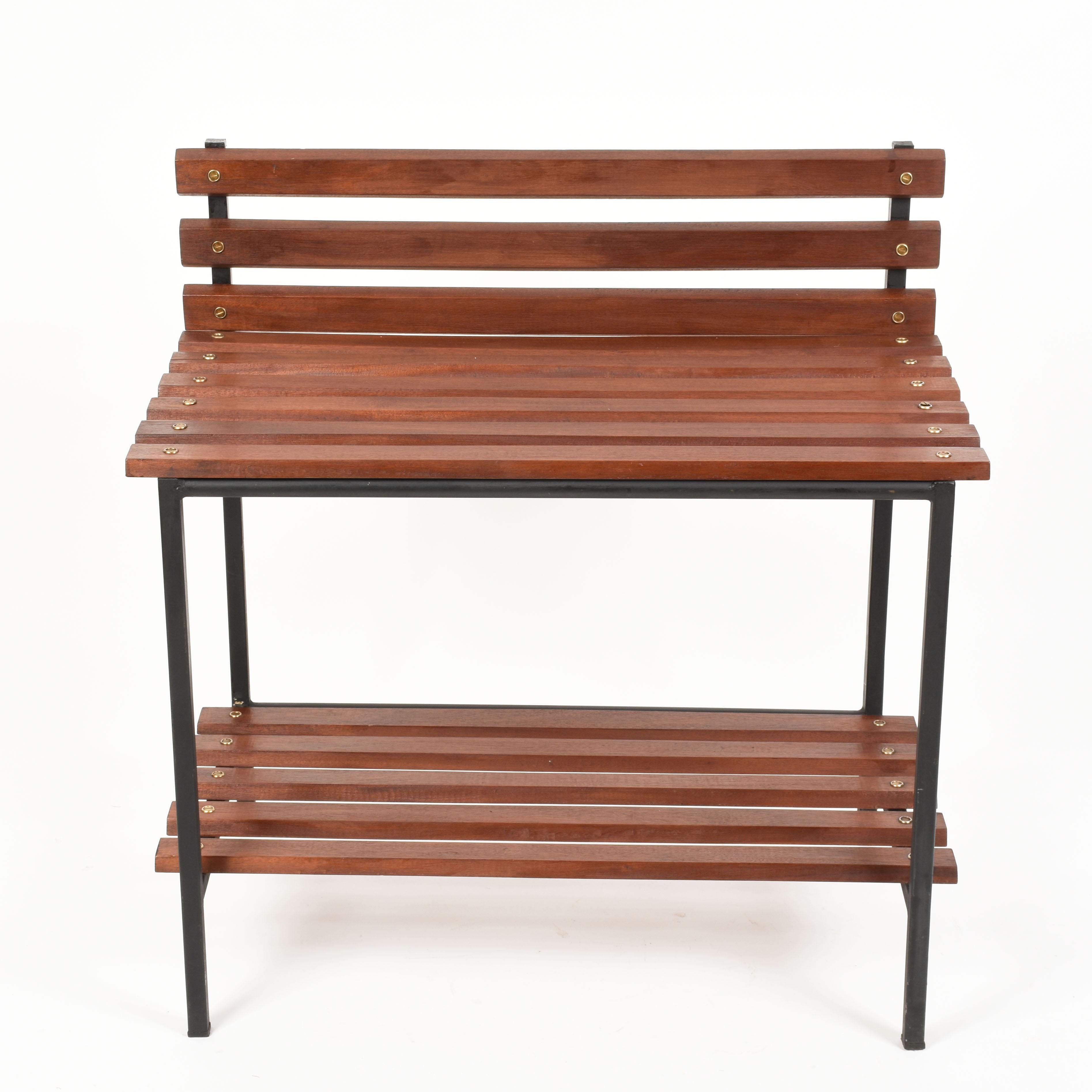 Midcentury teak, black enameled metal and brass bench. This wonderful piece was produced in Italy, during 1960s.

This bench is awesome as it has two floors and the horizontal lines are in teak while the vertical ones are in black enameled metal