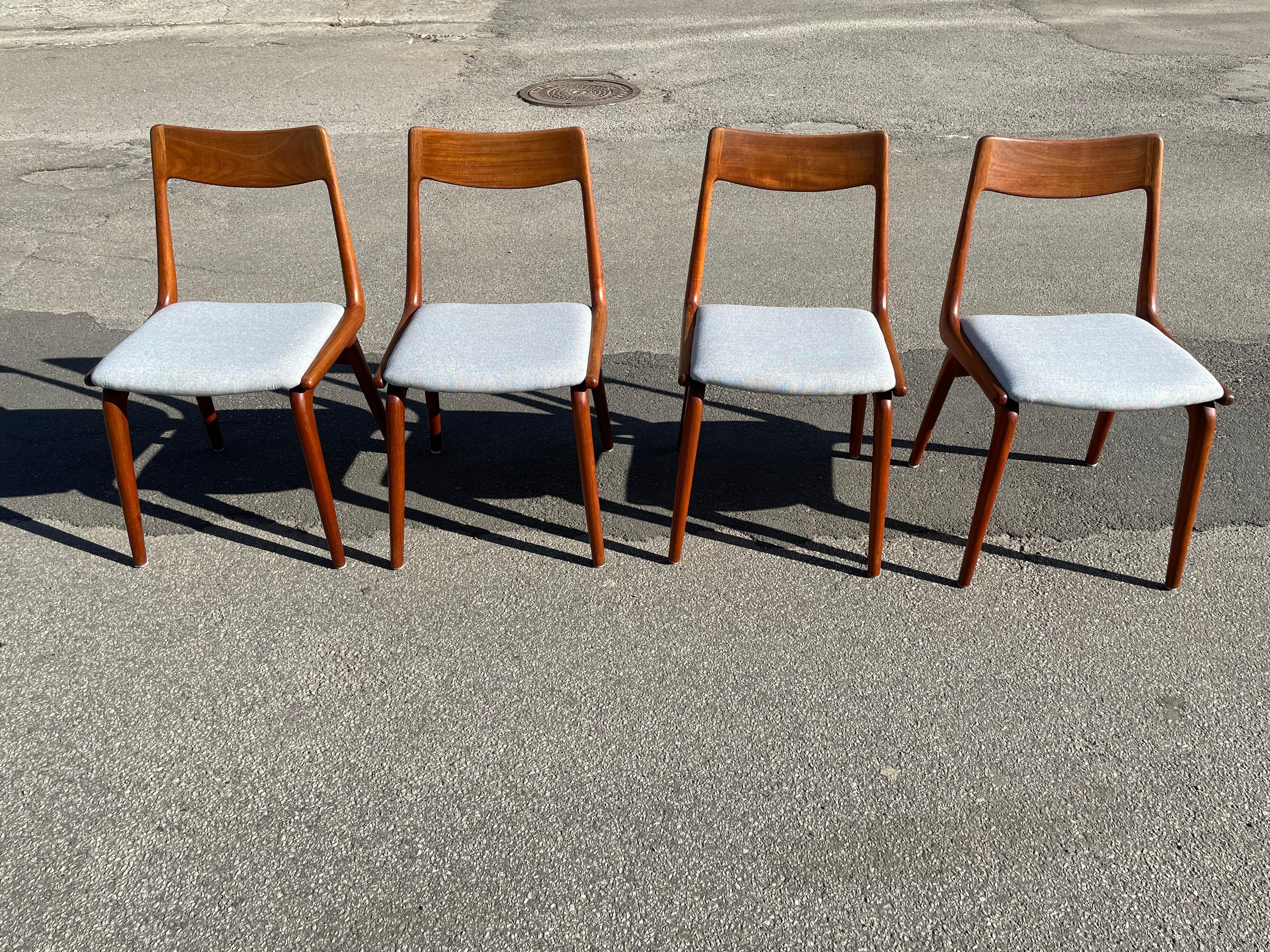 These Danish modern dining chairs from the mid-1960s were designed by Erik Christensen for Slagelse Møbelvaerk and are made from solid teak. The name and appeal of the chairs, numbered #370 is taken from the boomerang shape of the seat and back. The