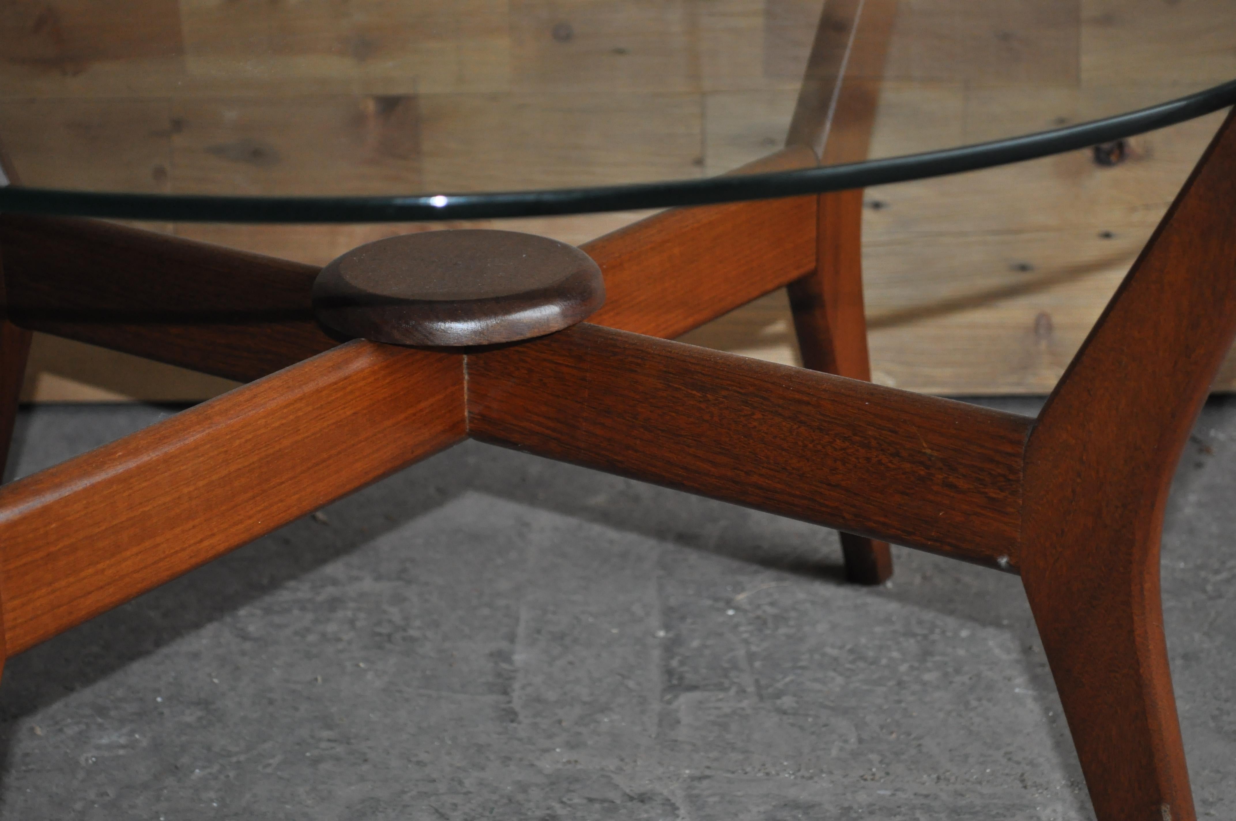 Midcentury floating coffee table.

Made with a solid Afrormosia (African teak) base
and 1/2 inch thick toughened glass floating top

Of beautiful quality and construction

Maker unknown however very Danish in style, unfortunately we 
have