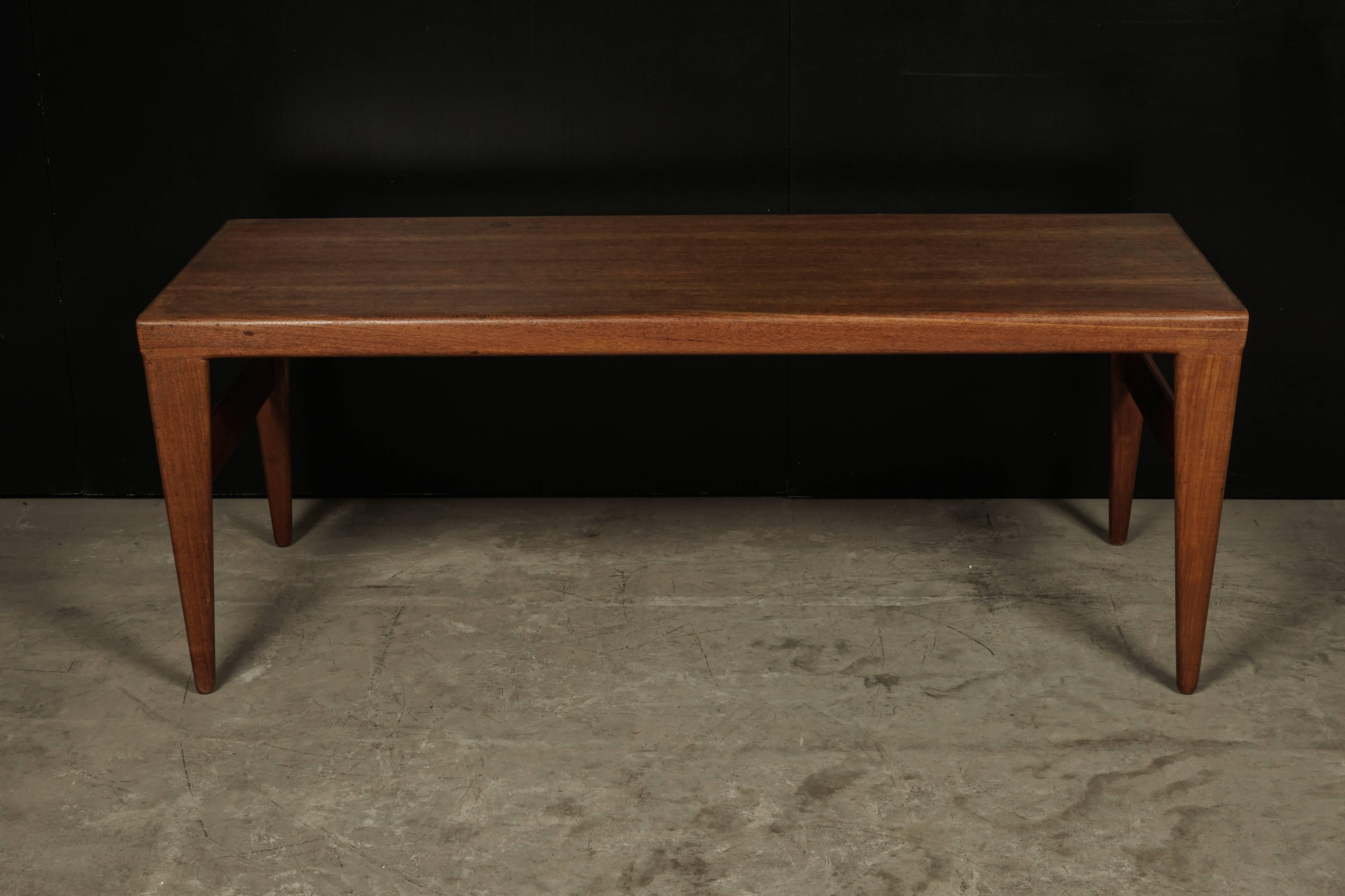 Midcentury teak coffee table from Denmark, circa 1970. Tapered legs with pull-outs on each side.