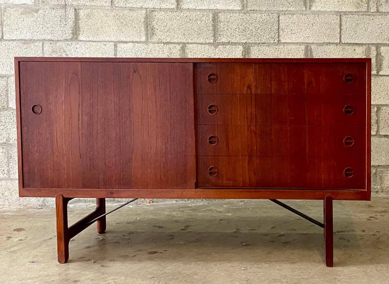 Incredible vintage MCM Danish teak credenza. Designed by the legends Aksel Bender Madsen and Ejner Larsen. Crafted by Narvstead Mobelfabrik in the 1960s. A super rare and elusive piece. Beautiful teak wood grain with sliding doors.