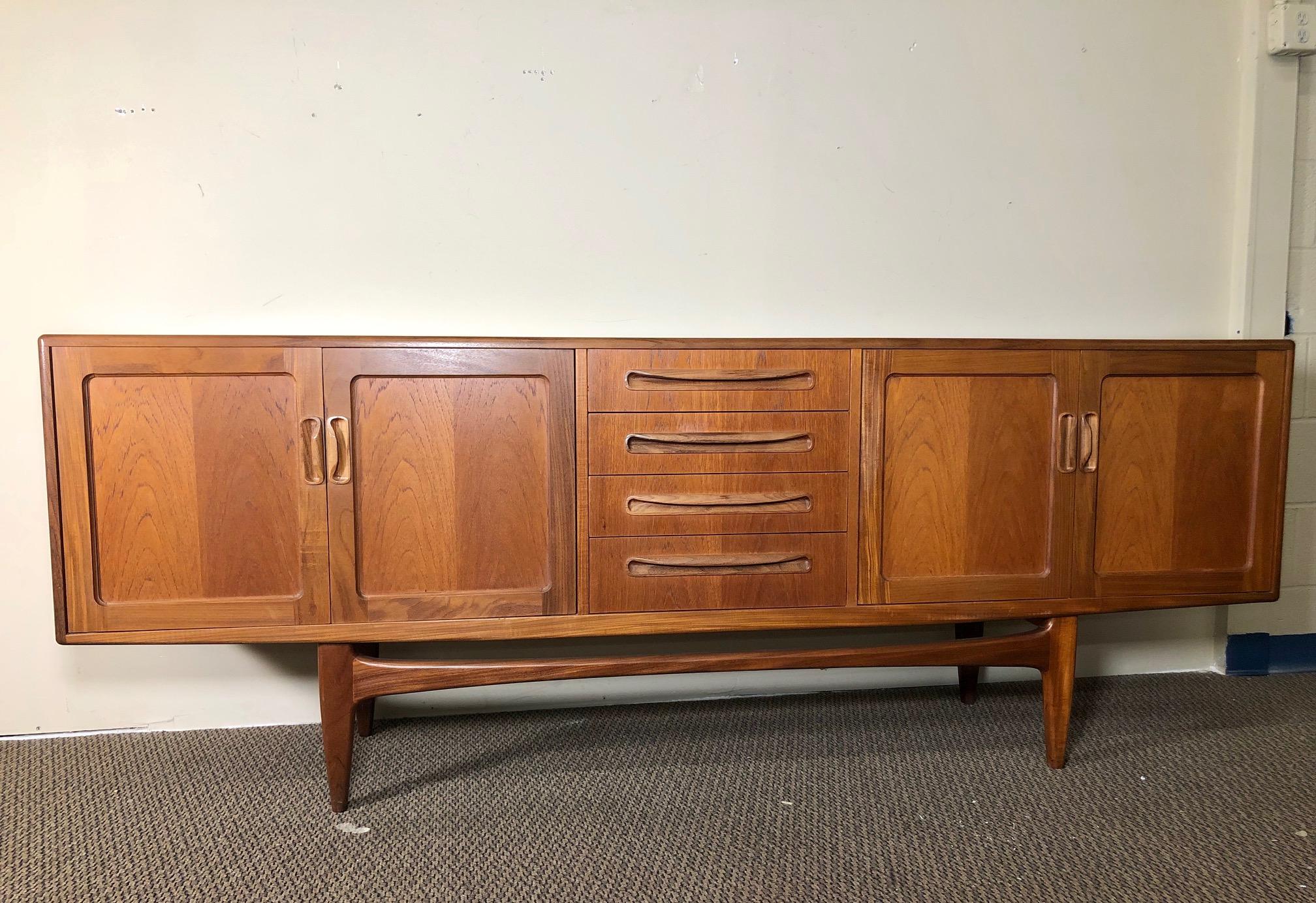 Outstanding teak credenza by G Plan with original gray fabric with silverware dividers in the top drawer.

It is in very good vintage condition. Nice clean interior. Some cup ring marks inside the cabinets, the gray fabric in the top drawer has