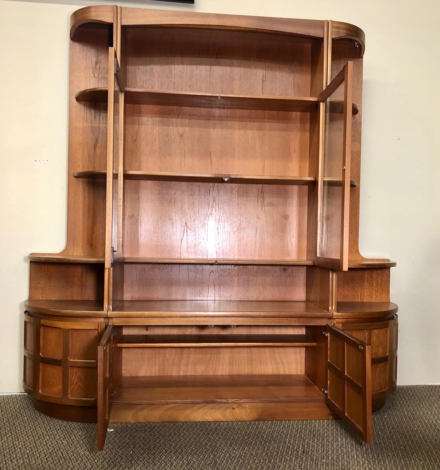 Fantastic teak wall unit made by Nathan Furniture. Made in England.

Features 2 smaller corner units and a main unit. The corner shelves are adjustable. Remove two small pins and slide shelf out to adjust. See last two photos. Original labels are