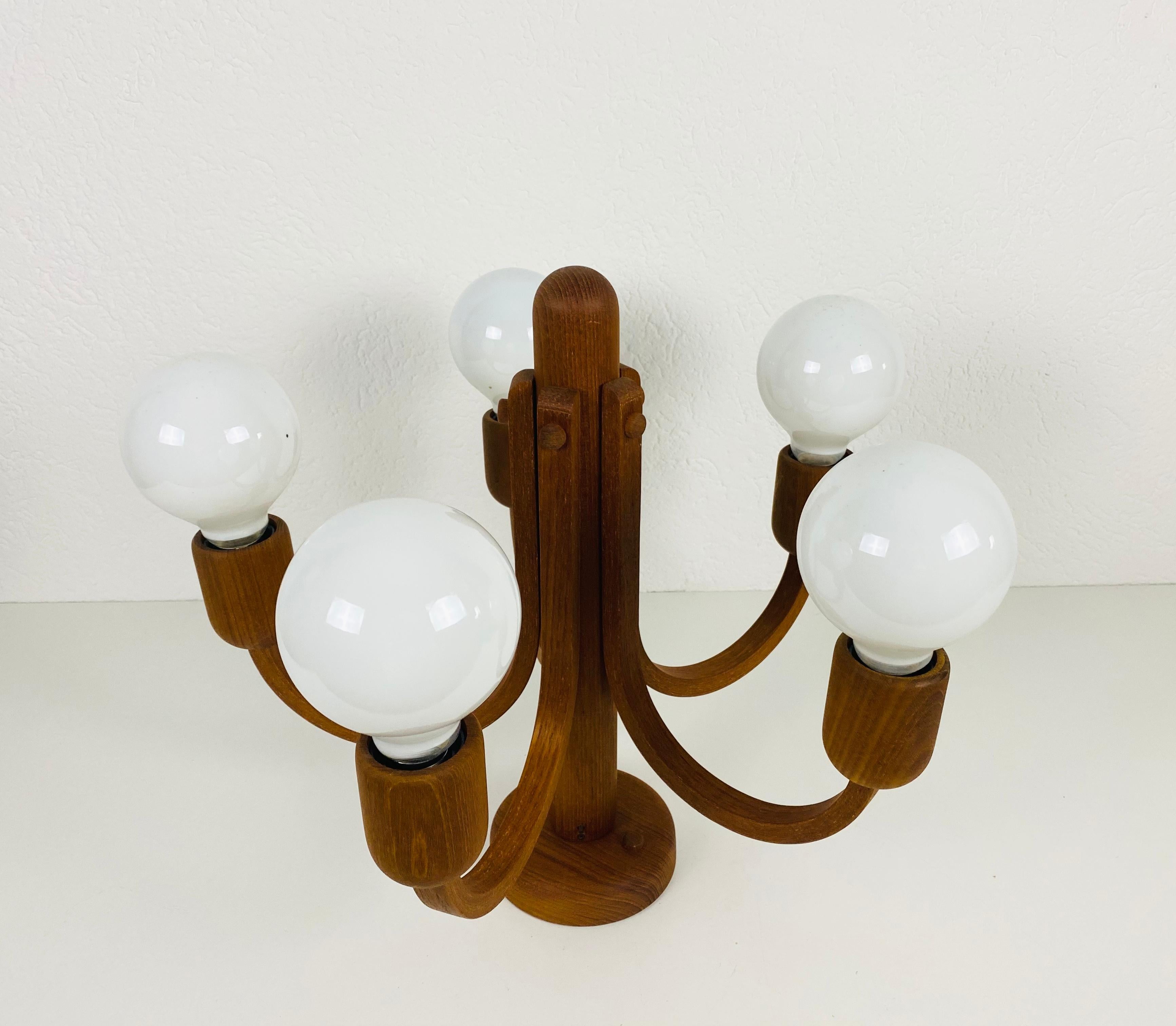 A wooden pendant lamp by Domus made in the 1960s. The body of the lamp is teak. The lamp has a wonderful Scandinavian design. 

Measurements:
Height 42 cm
Diameter 42 cm



The light requires 5 E27 (US E26) light bulbs. Works with both