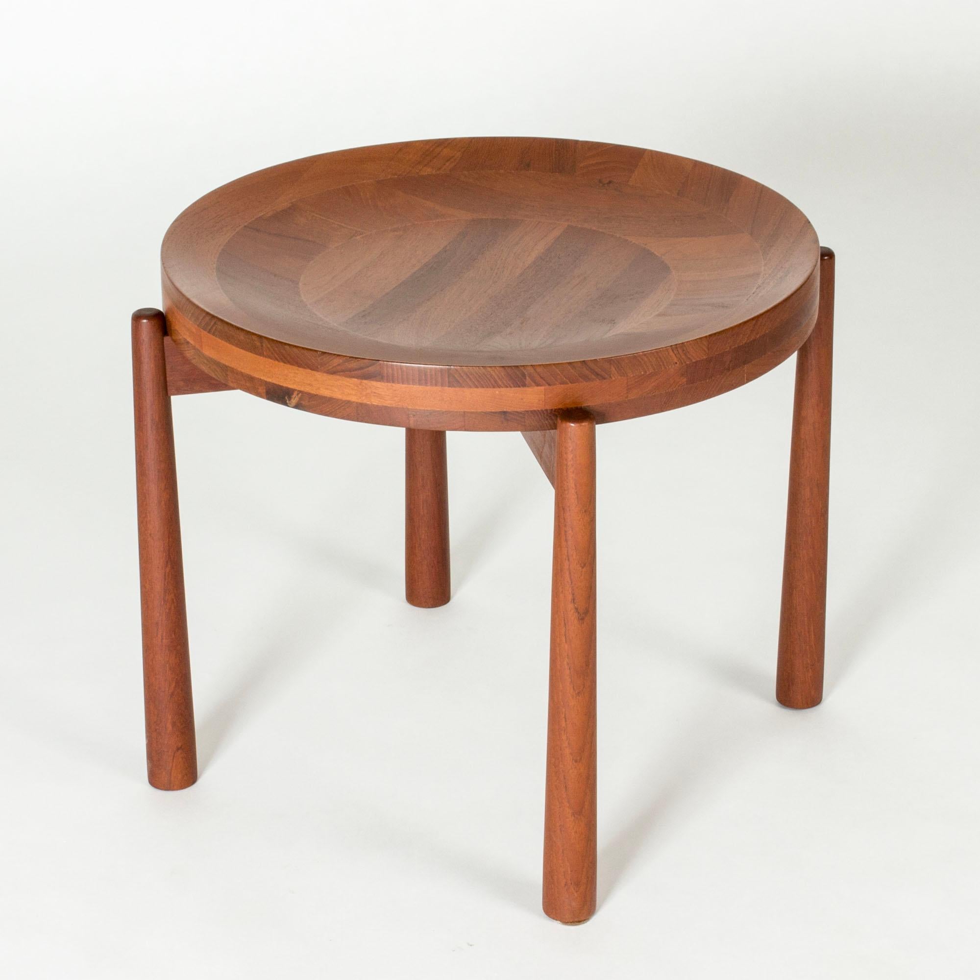 Lovely teak tray table by Jens Quistgaard. Solid wood tray that is slightly concave on one side. Can be turned around and serve as an ordinary table. Nicely balanced proportions, tapered legs.