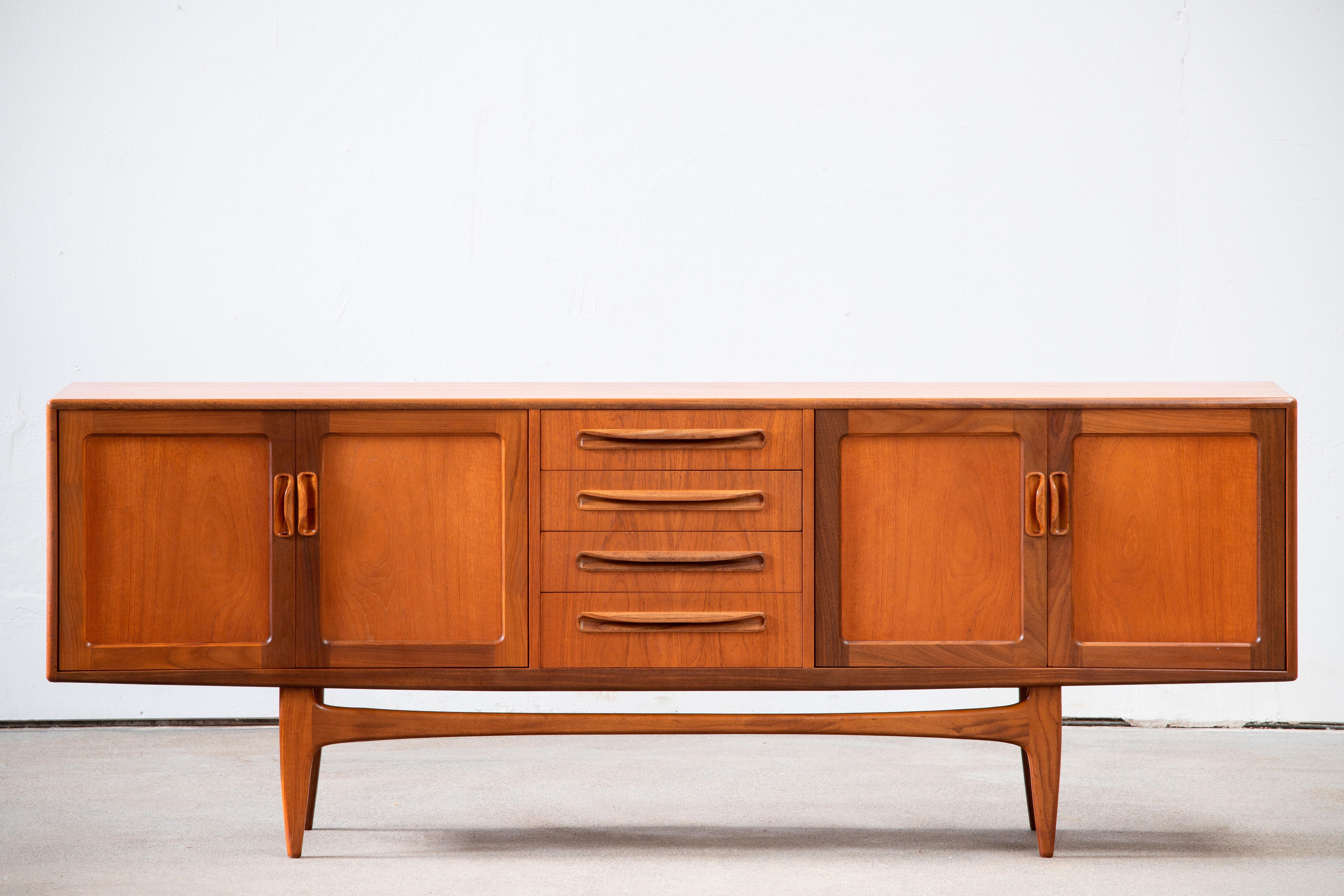 Midcentury teak sideboard Fresco by G plan from the 1960s. It is a shining example of the form and function synonymous with furniture of this era. It has is all; well-built, great design and heaviness. Four doors storage space and four drawers. The