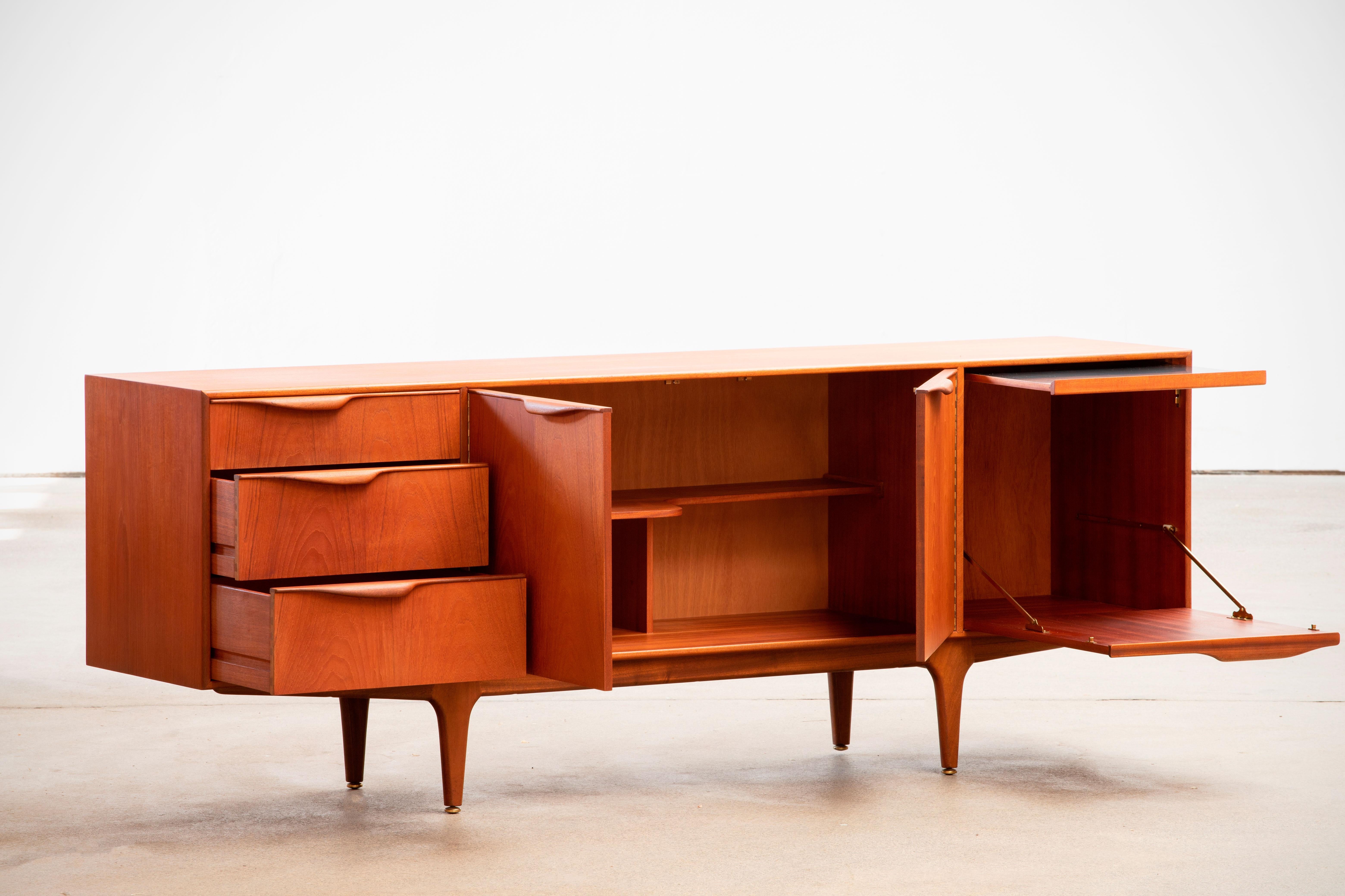 Midcentury teak sideboard Dunvegan by Mcintosh plan from the 1960s. It is a shining example of the form and function synonymous with furniture of this era. It has is all; well-built, great design and heaviness. Three doors storage space and three