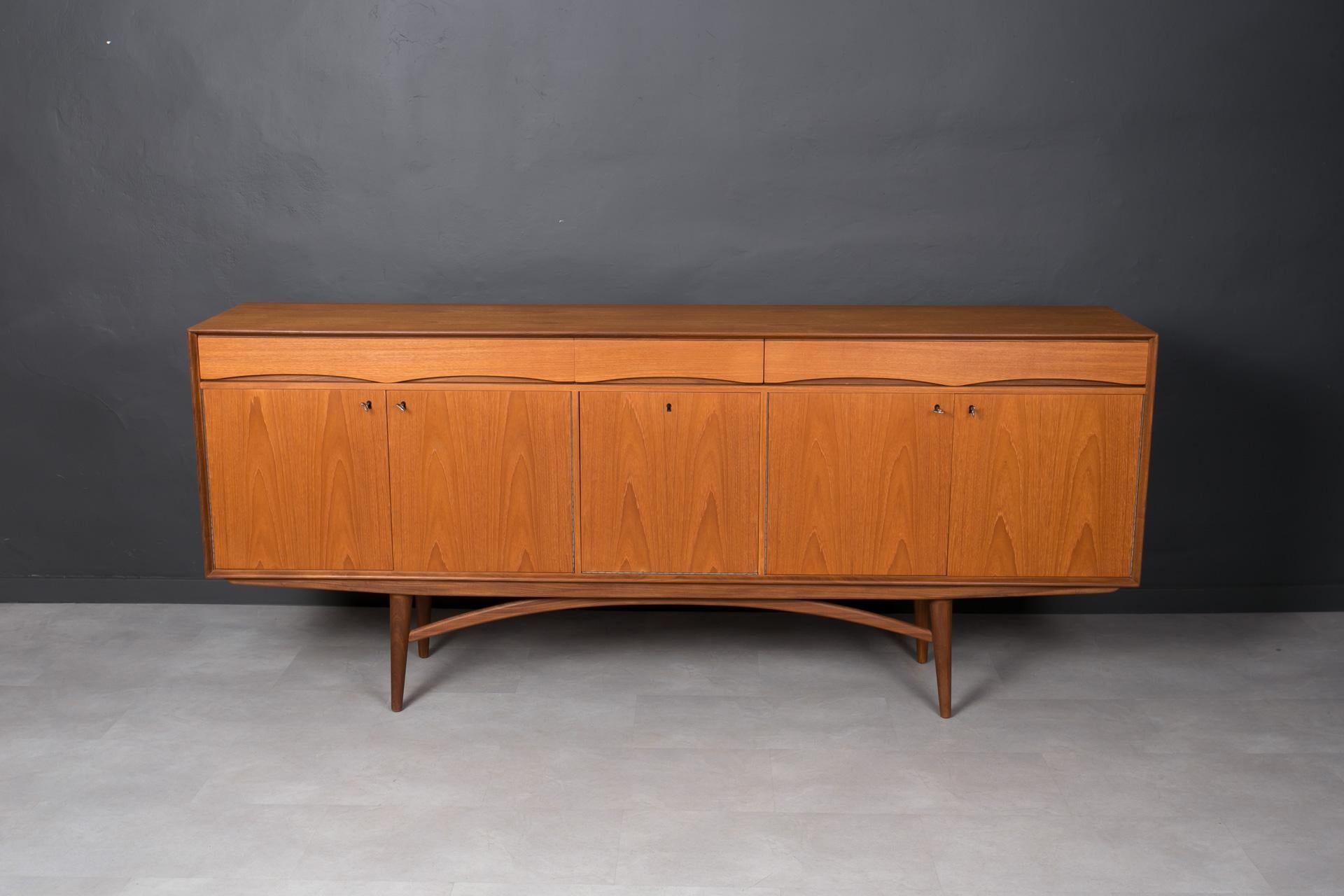 This teak sideboard comes from Norway and was made around 1960s. It is most probably one of Gustav Bahus designs. It has original stamp on the back that looks like Gustav Bahus stamp but it is not fully clear. It features three storage sections,