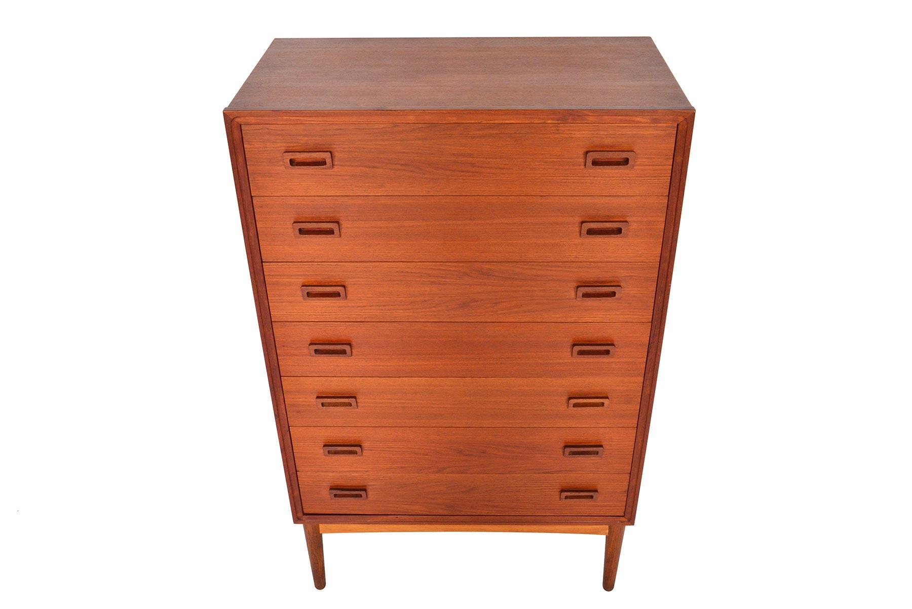 This wonderful Danish modern teak seven drawer highboy dresser is framed in sculpted afrormosia. Drawers are adorned with a pair of trapezoidal pulls. In excellent original condition.

