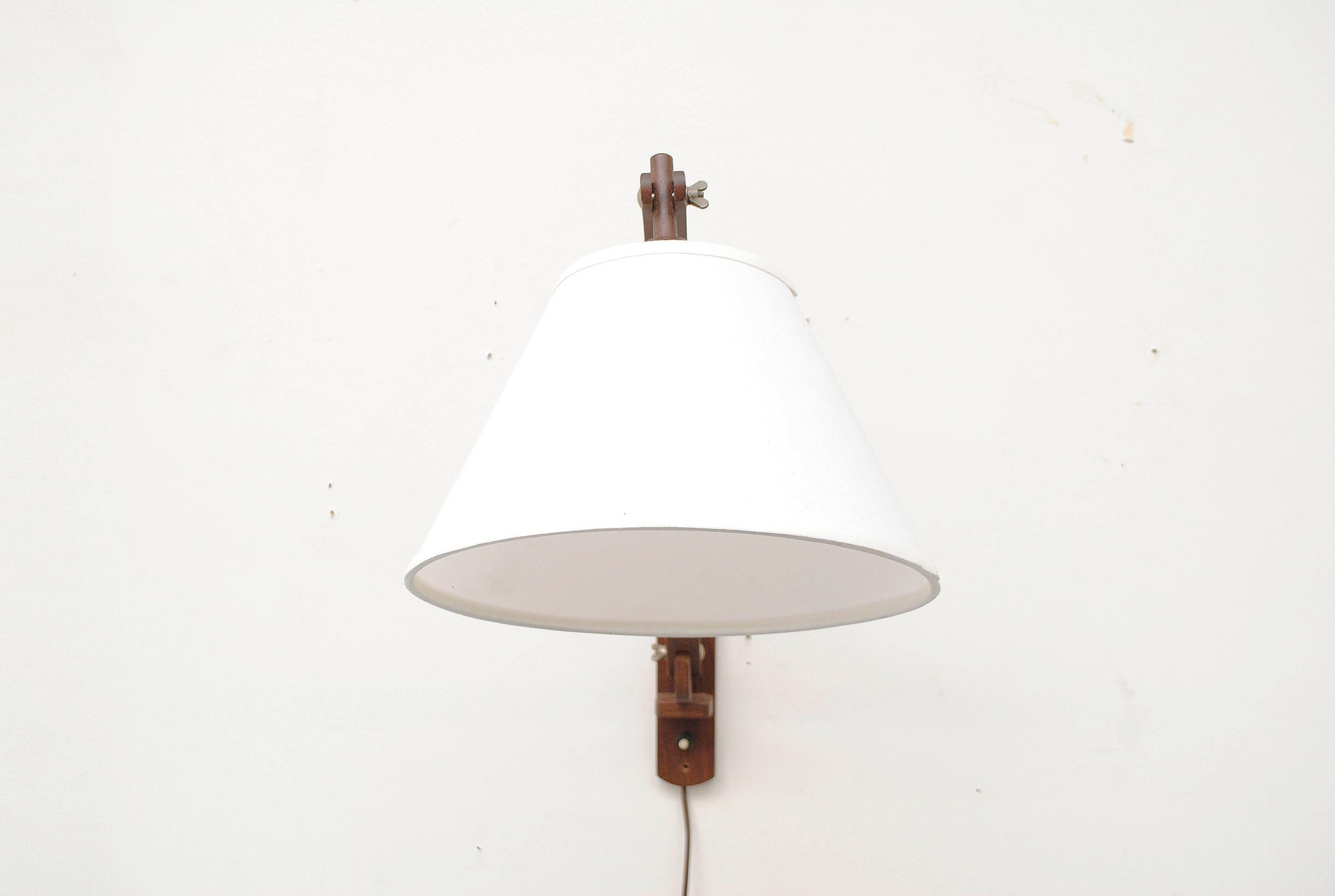 Teak swan neck wall lamp with adjustable positioning. Newly made white linen cone shade. Teak in good original condition.