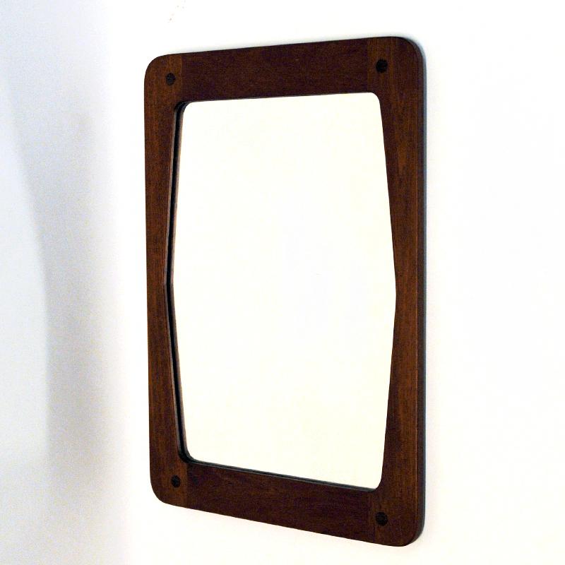 Lovely teak wall mirror by Hans-Agne Jakobsson for Åhus AB -Sweden 1950s. Model 2591/S650. A perfect mirror to be placed both horizontal and vertical on the wall. Marked on the backside with Hans-Agne Jakobsson and Åhus AB. Numbered 2591/S650. The