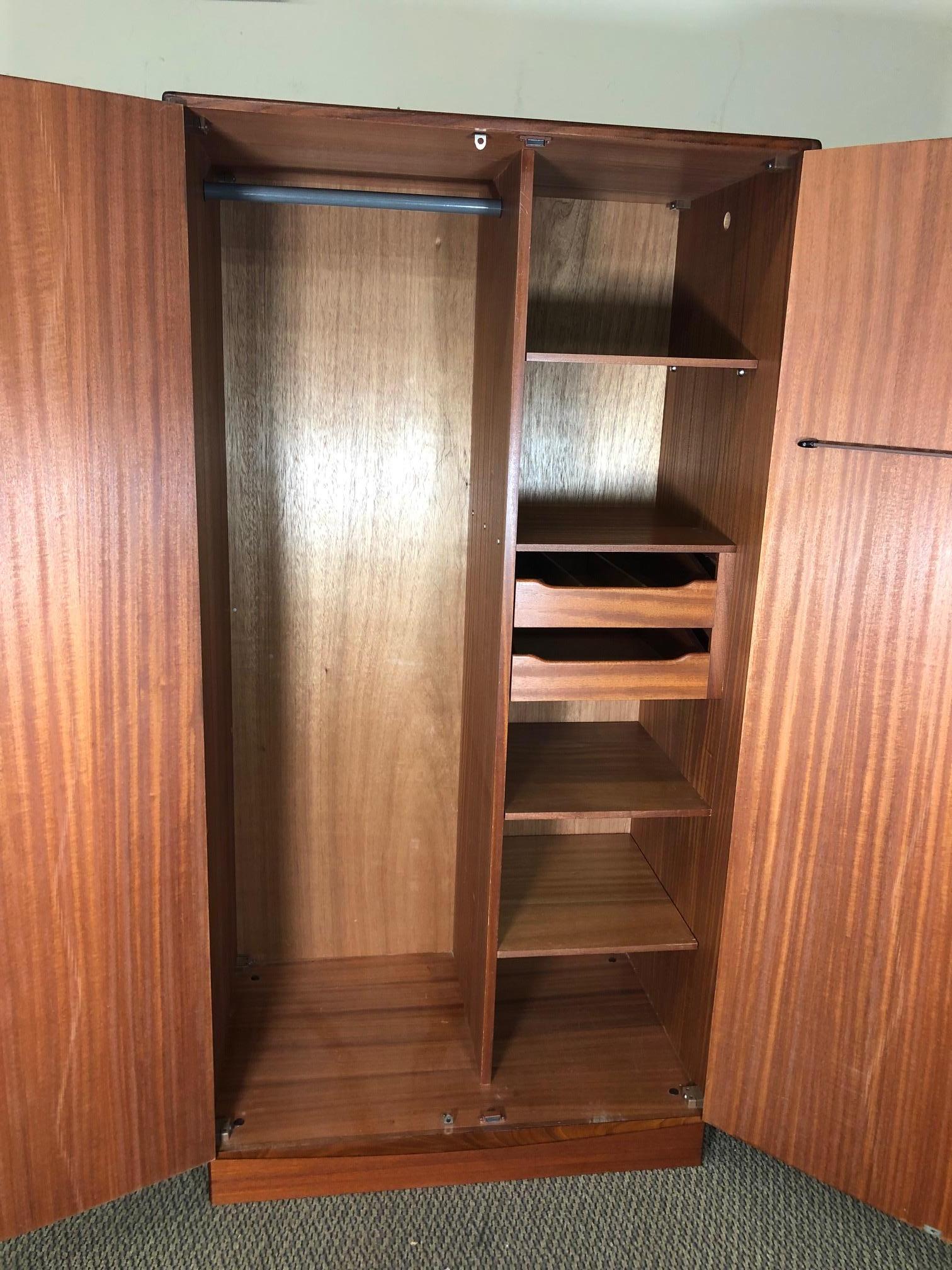 Amazing teak wardrobe by G Plan. Designed in the 1960s by Victor Bramwell Wilkins for G Plan's Fresco Range. Danish modern in style.
Two-door wardrobe with half hanging space on the left side and shelves and drawer space on the right. Top drawer