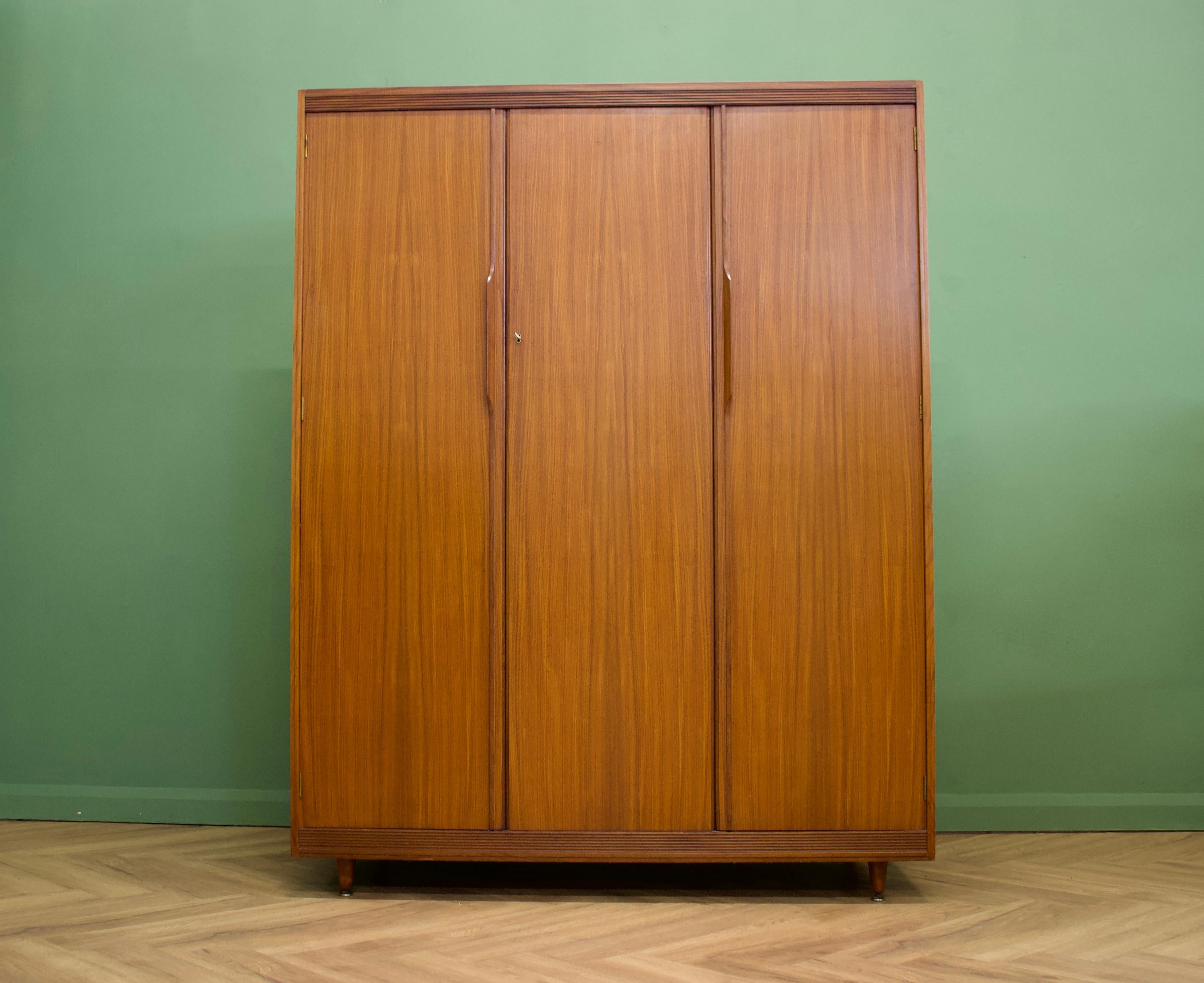 Mid-Century Modern wardrobe.
Manufactured by White and Newton in the UK.
Made from teak & teak veneer.
Featuring two compartments with hanging rails to each.