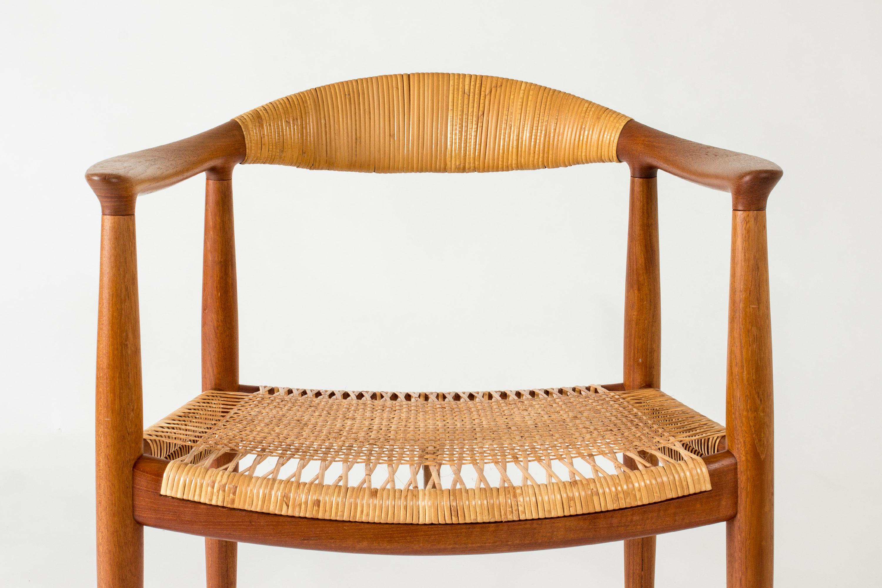 Beautifully designed and crafted teak and rattan “The Chair” armchair by Hans J. Wegner.

“The Chair” was designed in 1949 and became a huge success upon its launch. The model was important in advocating Danish design internationally. Its iconic