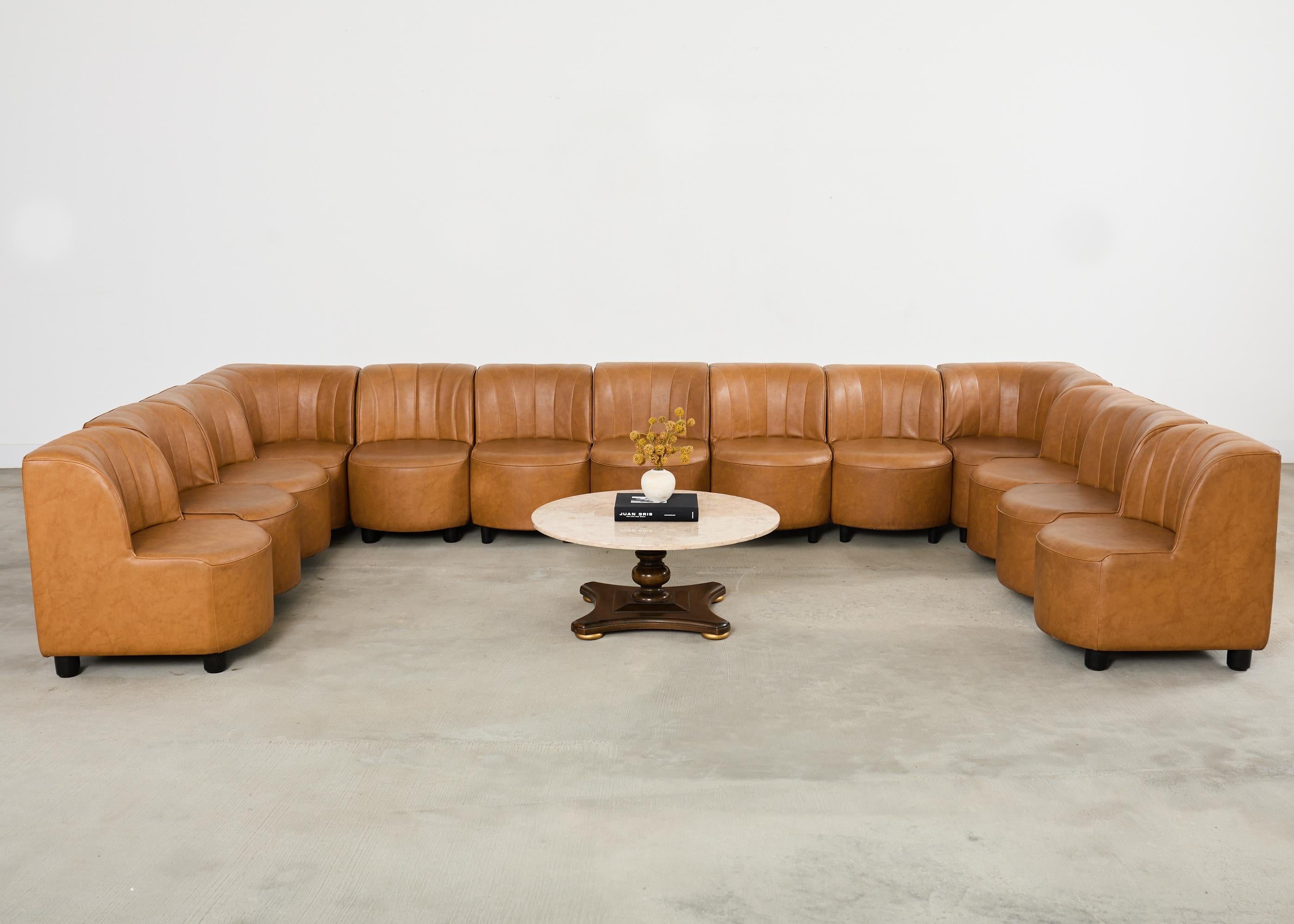 Monumental Italian mid-century modern 13 piece modular sectional sofa in the style and manner of Tito Agnoli for Arflex. The 9000 sofa design consists of individual seats with rounded fronts and curvaceous chanelled backs. The sides are flush and