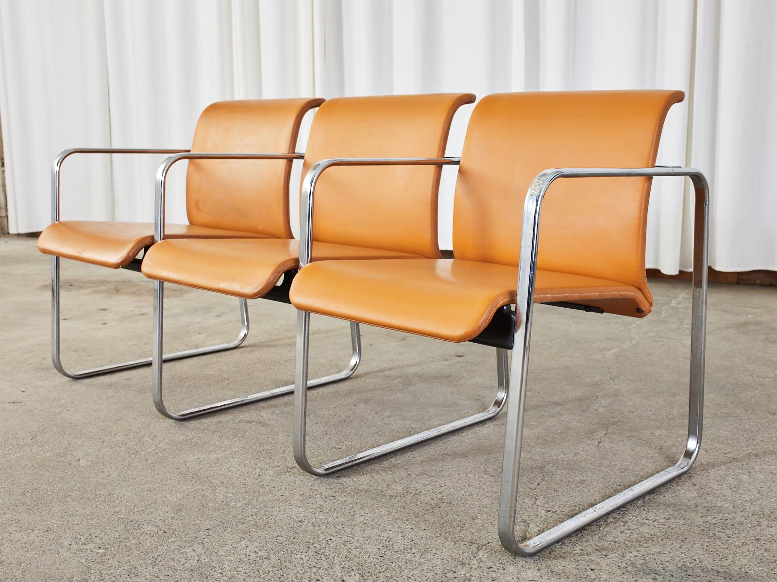 Rare Mid-Century Modern three seat tandem bench armchair designed by Peter Protzman for Herman Miller. The chair is constructed from flat bar tubular steel with a chrome finish. A set of four chrome leg/arm squares are conjoined by hidden stretchers