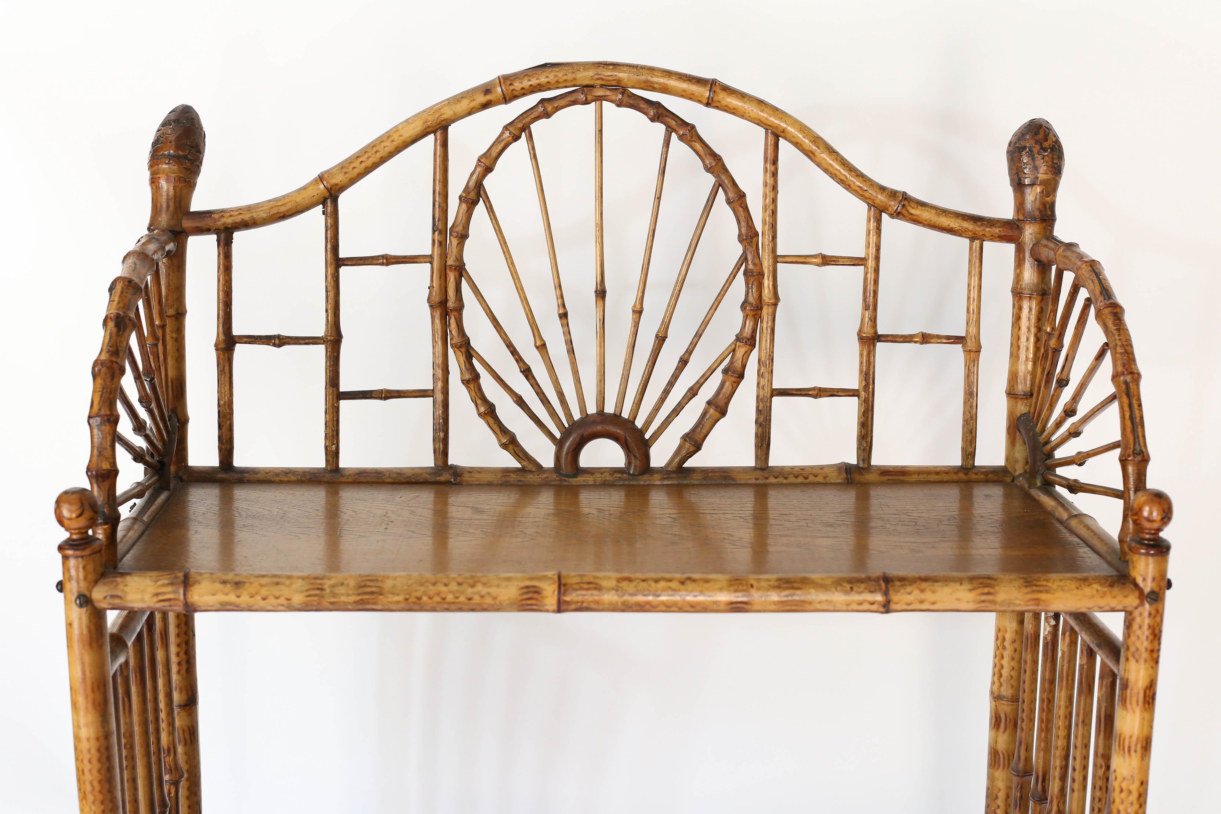 Found in England, a fabulous midcentury three tier shelf with spoke wheel detail. The work on this piece is exquisite in detail. A must have piece.