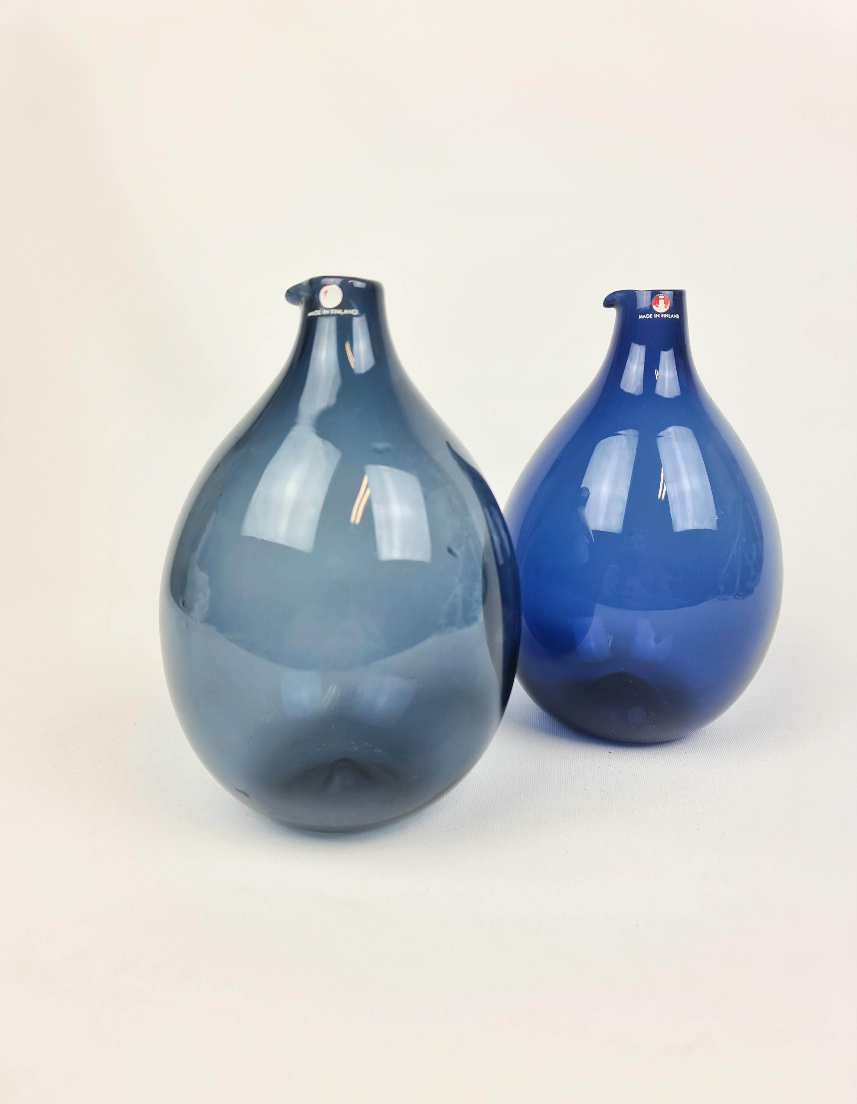 The bottles were produced by Iittala in 1956-1962 and designed by Timo Sarpaneva. 

Fully signed in the bottom of them. 

Measures H 16 cm, D 12 cm. 

 