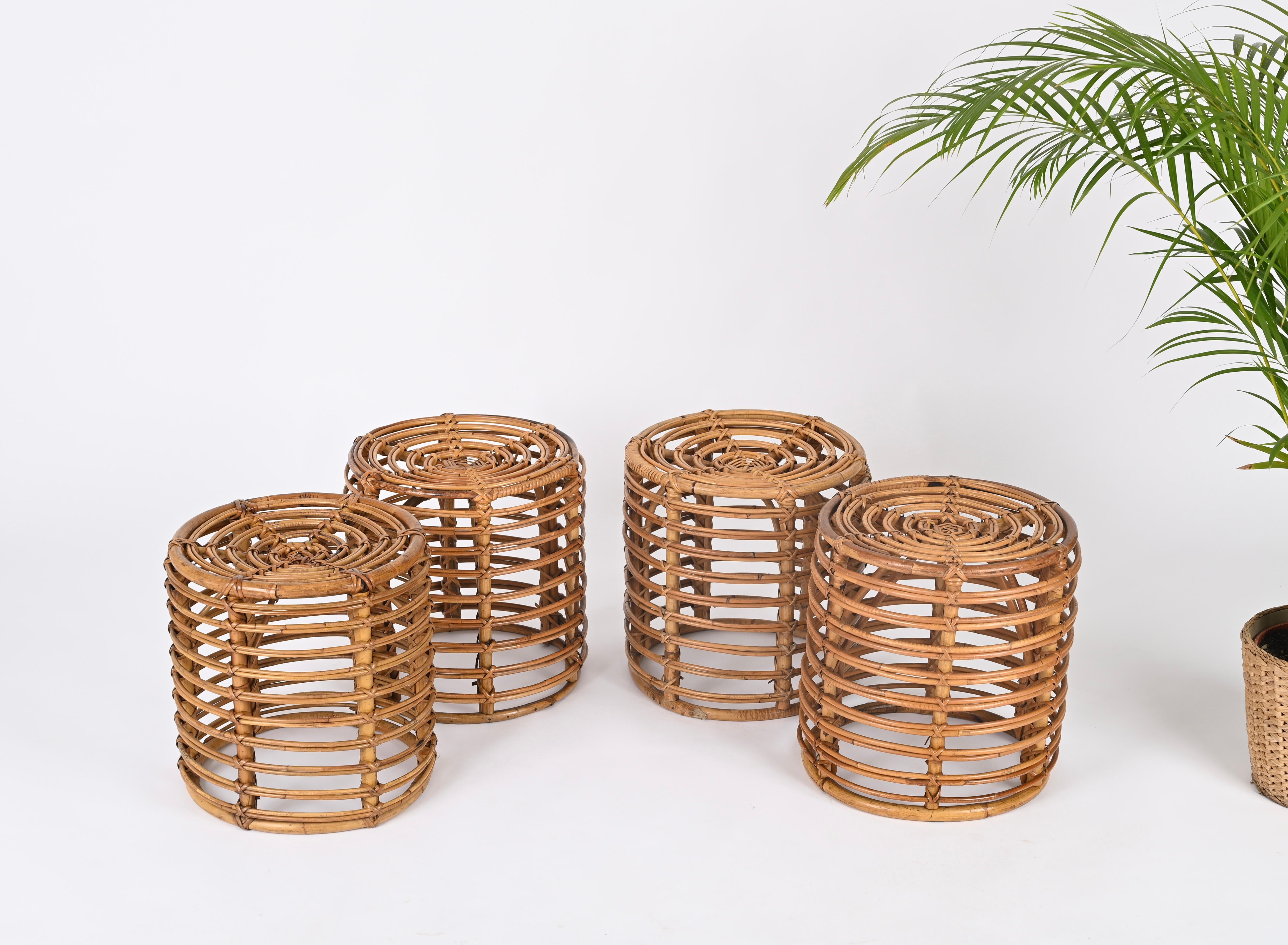 Stunning set of 4 poufs in curved rattan, hand-woven wicker and bamboo designed by Tito Agnoli. These fantastic and rare poufs were made in Italy during the 1960s.

The craftsmanship of these stools is exceptional and the curved bamboo structure