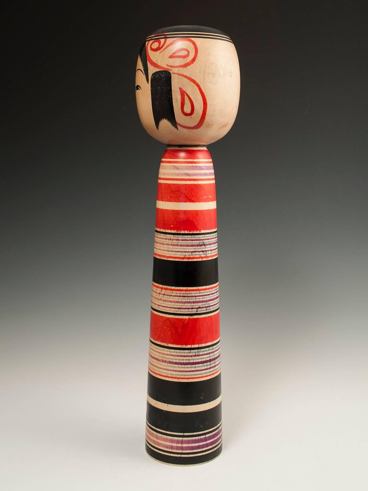 Offered by Zena Kruzick
Midcentury traditional Kokeshi doll from Tsuchiyu, Japan.

A classic traditional kokeshi doll signed by Imaizumi Genji (1934-). 
Kokeshi from the Tsuchiyu area of Japan are characteristically decorated with stripes, which are
