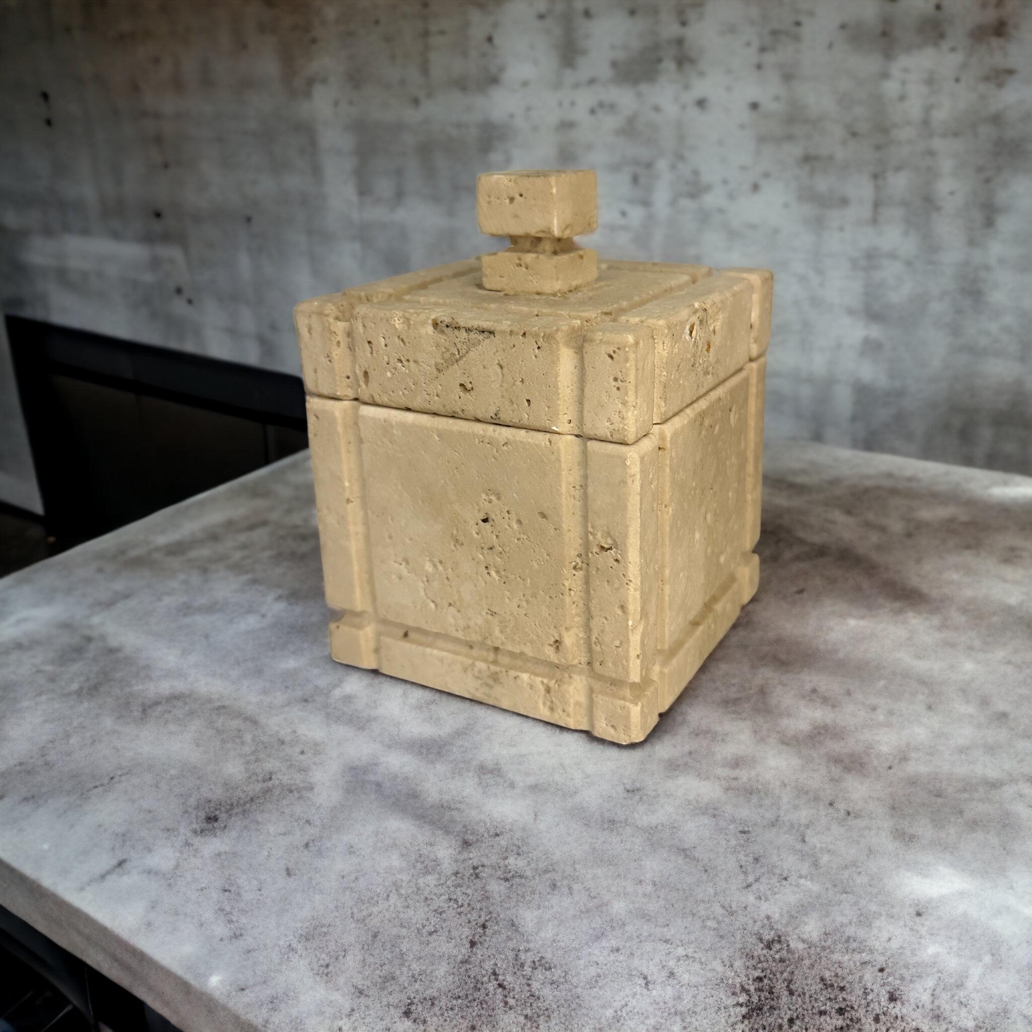 This beautiful square-shaped box in Travertine Marble is a wonderful example of Italian decorative objects production during the 1970s.  Made by Fratelli Manelli, the color and the texture of the marble, together with the pure and geometrical