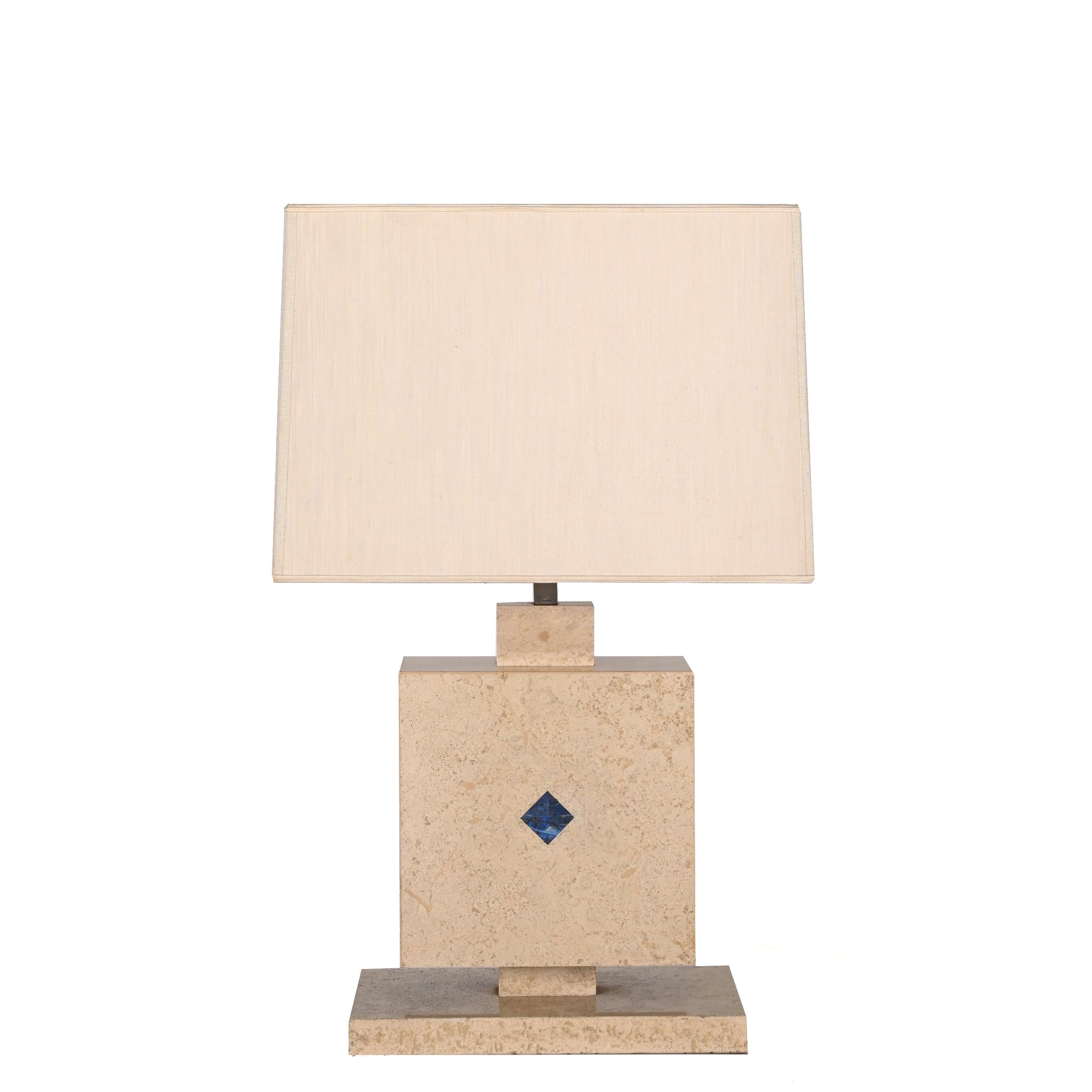 Amazing midcentury travertine marble with lapis lazuli stone table lamp. This fantastic item was designed in Italy during the 1970s. 

The fusion of materials and shapes is breathtaking: a rhombus lapis lazuli stone is embedded into a square