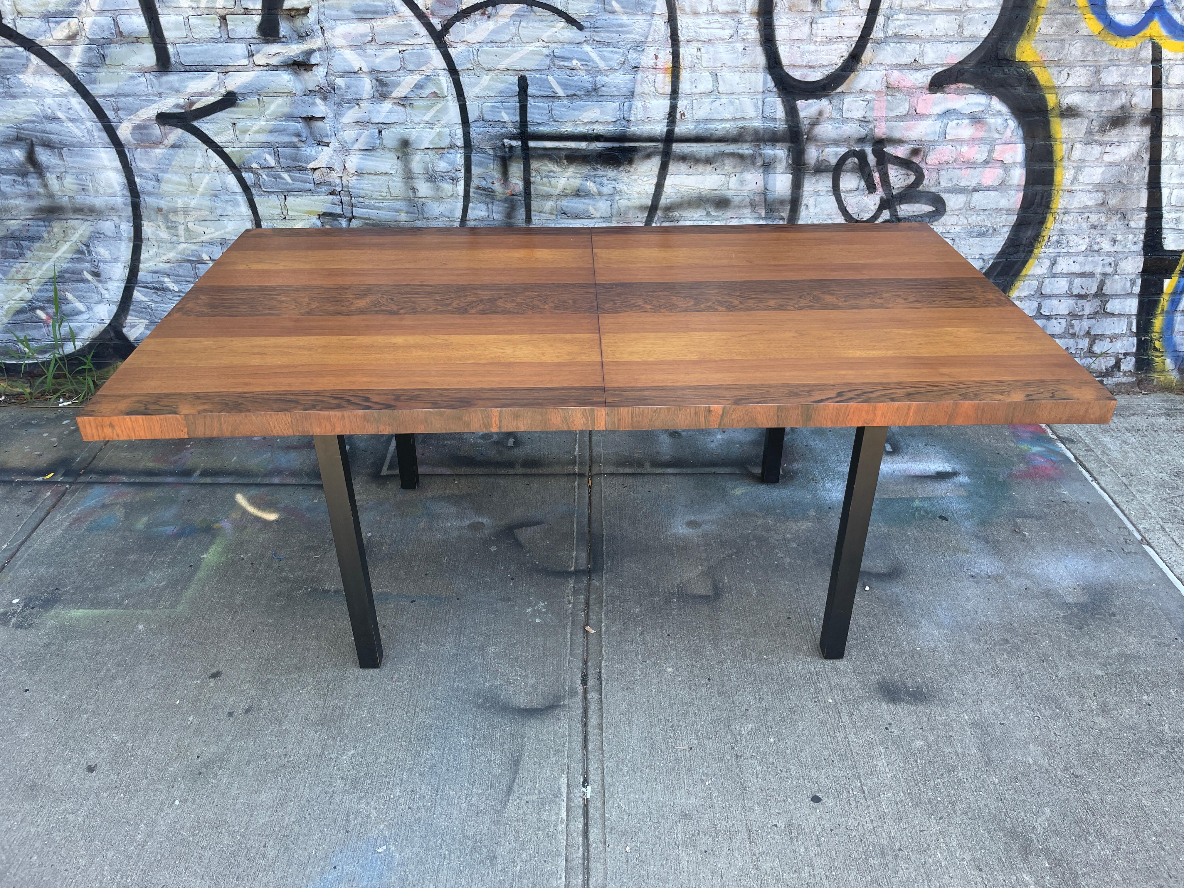 Mid-Century Modern American Danish style dining table by Milo Baughman. Beautiful tri-wood veneer table made in USA. Amazing teak, rosewood and walnut table. Made circa 1960 all black lacquered solid wood legs. Original finish in excellent vintage