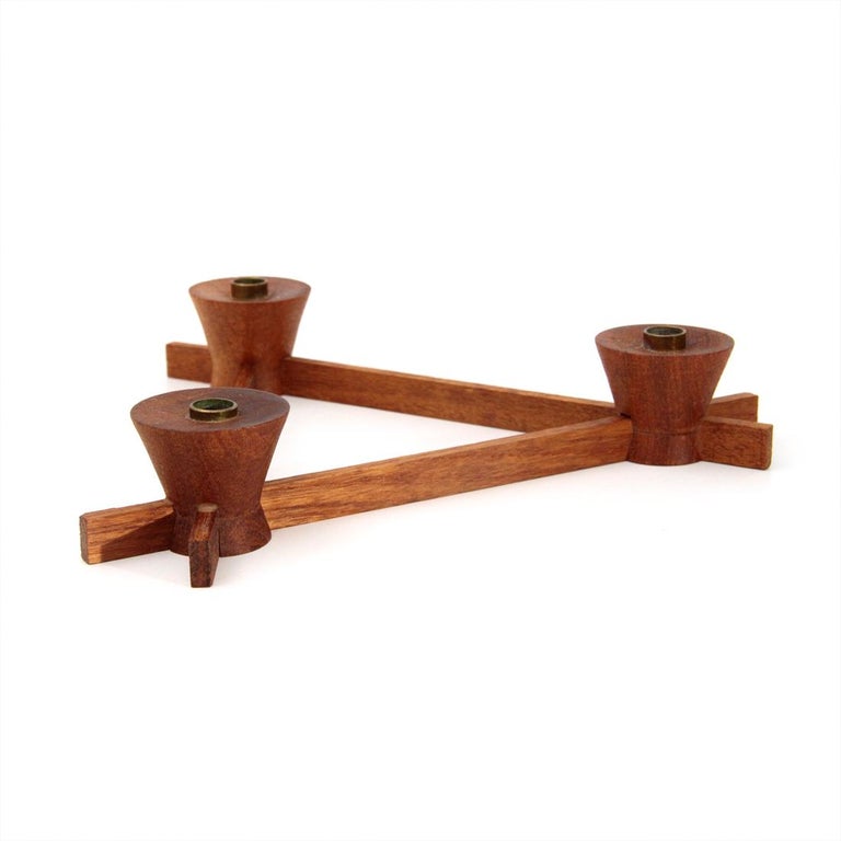 Candleholder produced by Anri Form in the 1960s.
Solid teak wood structure.
Brass holder.
Good general conditions, some signs due to normal use over time.

Dimensions: Length 23 cm, depth 23 cm, height 4 cm.