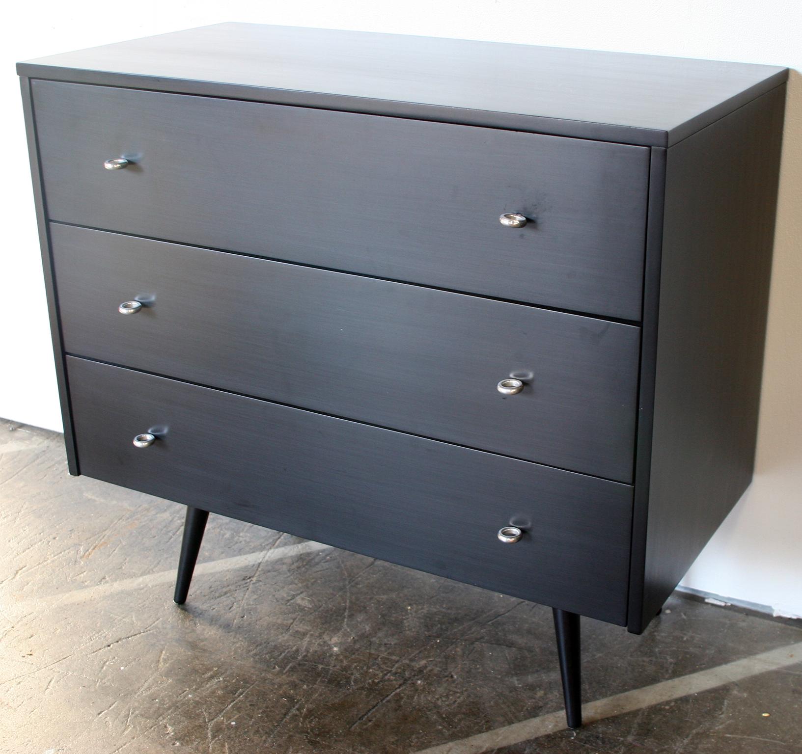 Beautiful midcentury low dresser triple drawer dresser by Paul McCobb, circa 1950 planner group #1508 with 3-center drawers. Solid maple construction has a Beautiful black lacquered finish. All original aluminium ring pulls sits on 4 solid maple
