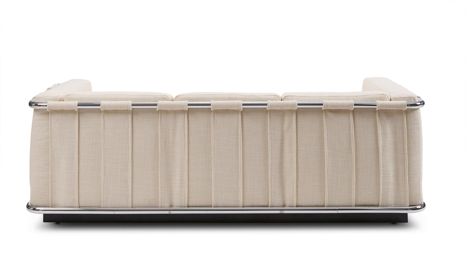 Elegantly tailored tuxedo-style midcentury sofa. Freshly reupholstered in a cream colored wool weave. This piece is fully finished, and has had all padding and cushioning replaced. Polished tubular chrome juxtaposes an ebony plinth base.