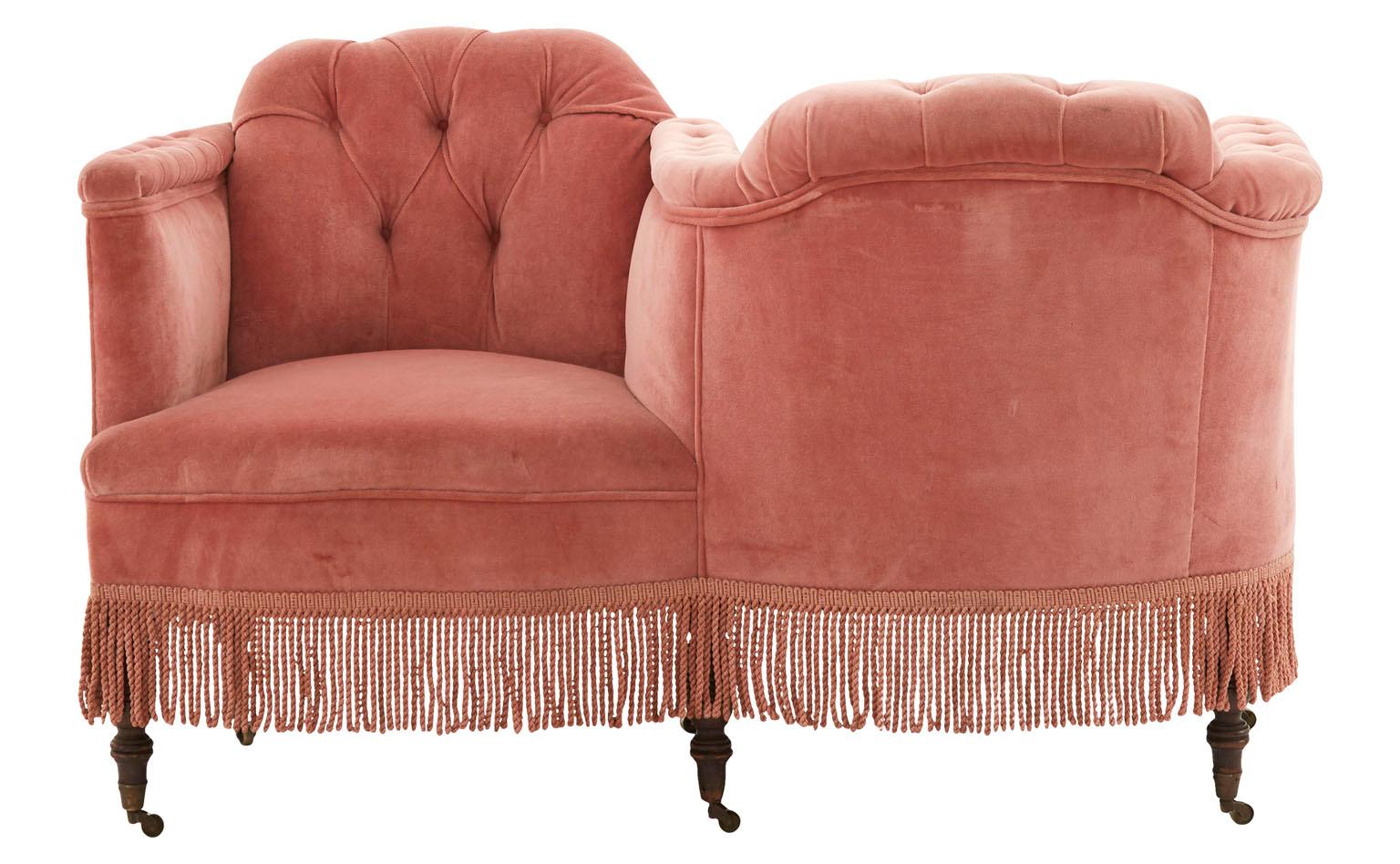Named for the French for “face to face,” our Vintage Tête-à-Tête was made in America in the mid-20th century. This unconventional S-shaped seat features its original pink velvet upholstery, lightly worn with some markings. It’s paired with neat