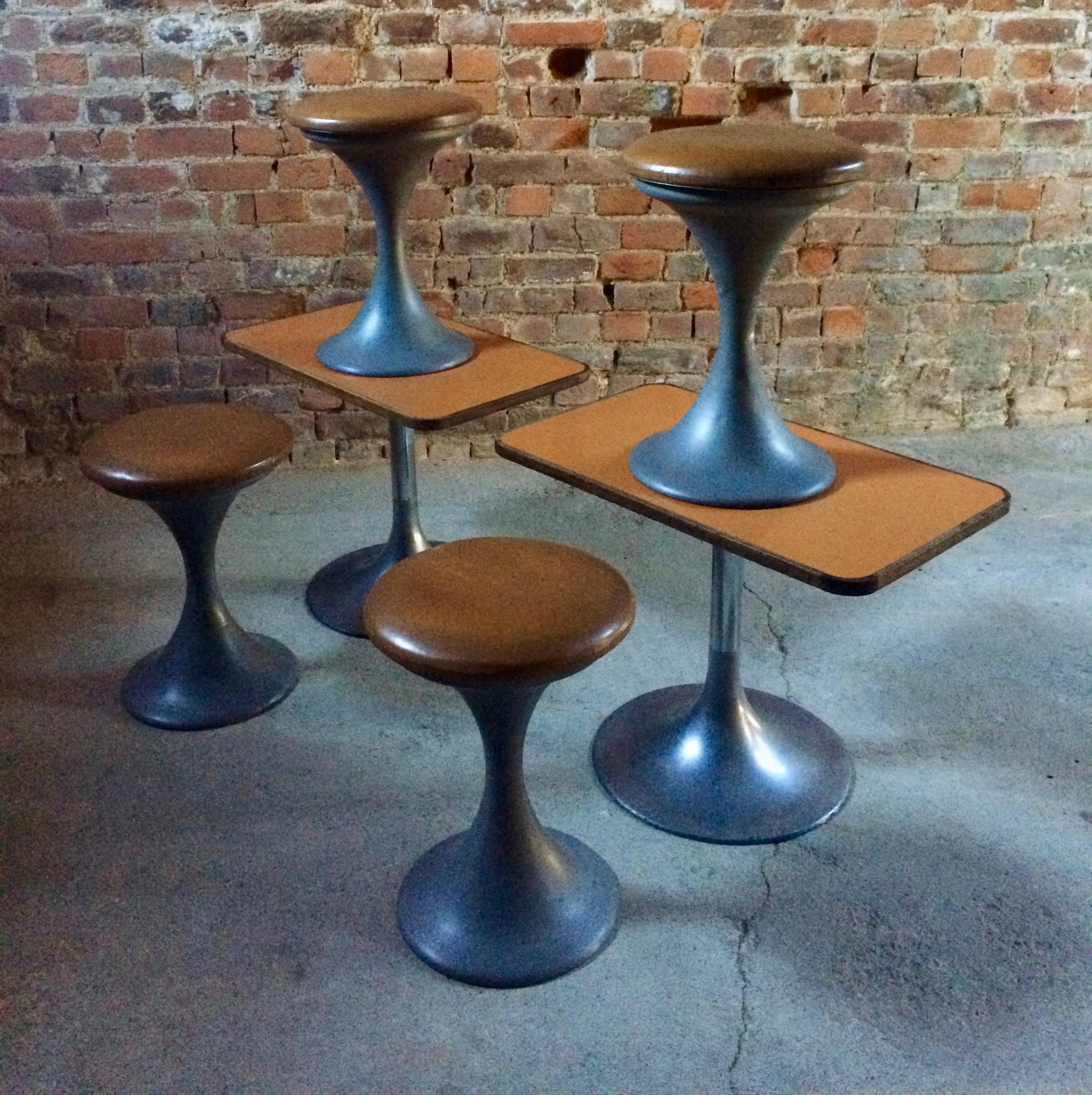 Fabulous midcentury Danish design bar or bistro set of two low tulip tables with formica tops and a matched set of four tulip stools, with brown leather seats and metal bases, circa 1960s.

Please note: The color of the stool bases are as shown in