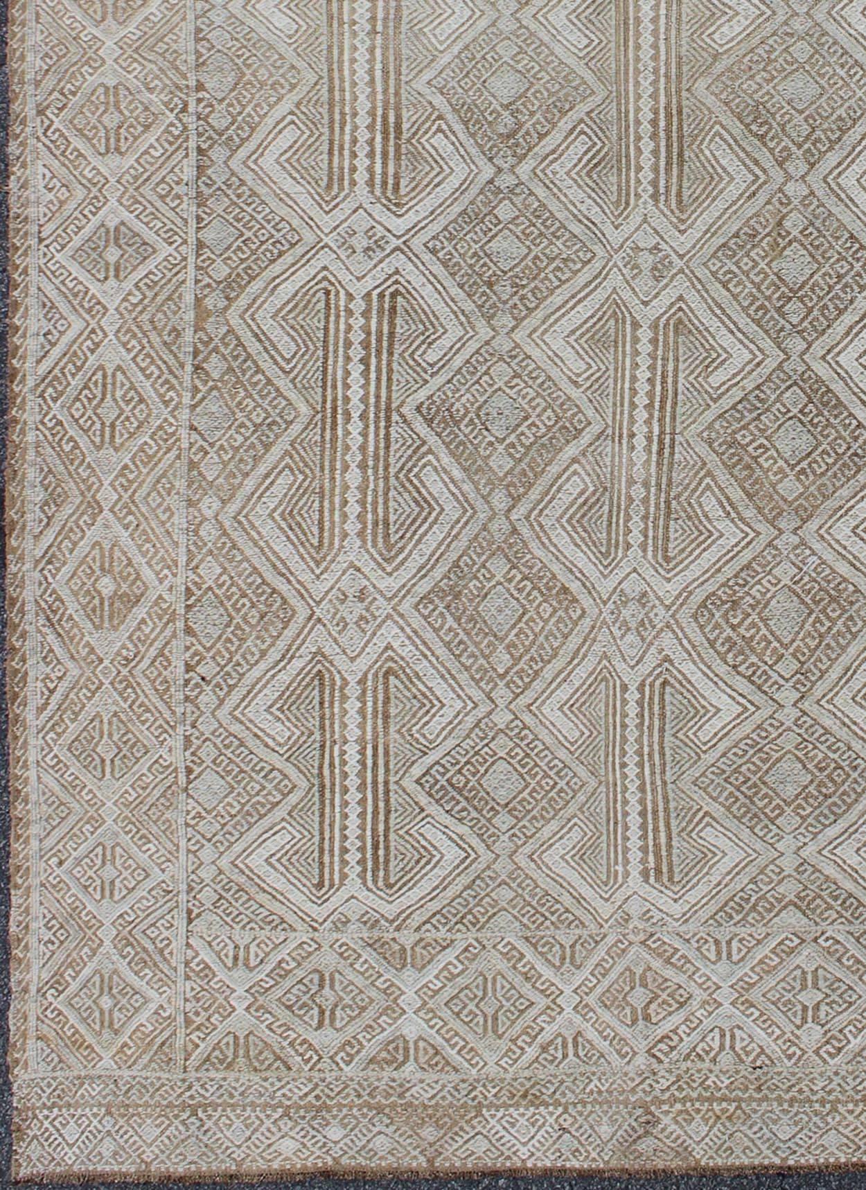 Midcentury Turkish Embroidered Flat Weave with all-over geometric design in ivory, taupe, light brown and neutral tones. Keivan Woven Arts/rug en-141075, country of origin / type: Turkey / Kilim, circa 1950.

Measures: 6' x 10'.

This delightful
