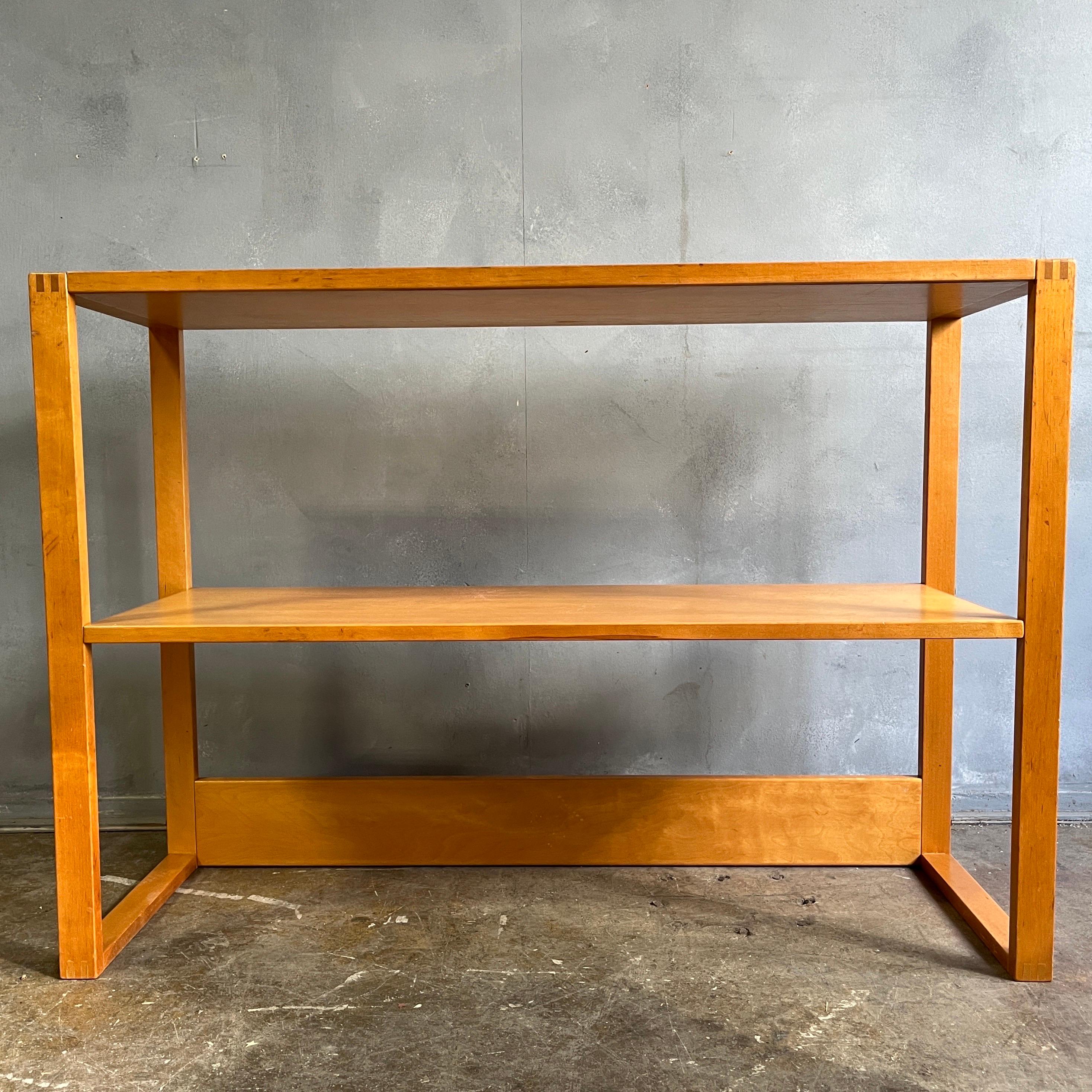 Midcentury two tier bookcase featuring a fixed middle shelf on sled base. Beautiful finger joints and brass screw details with original patina. Very solid handsome piece that would pair well with Mccobb, Eames, or Aalto designs.

Bottom shelf is