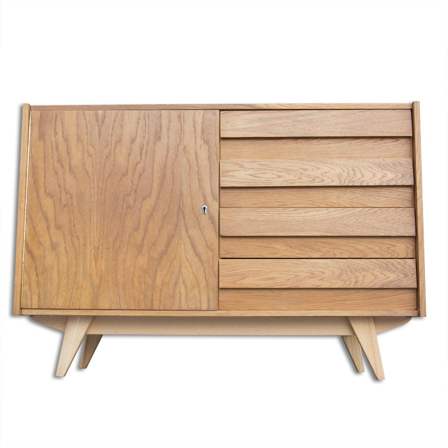 This beech and plywood sideboard, model U-458, was designed by Jirí Jiroutek and produced by Interier Praha during the 1960s. This model is associated with the world-renowned Brussels Period Expo 58 and features four drawers. The unit is in