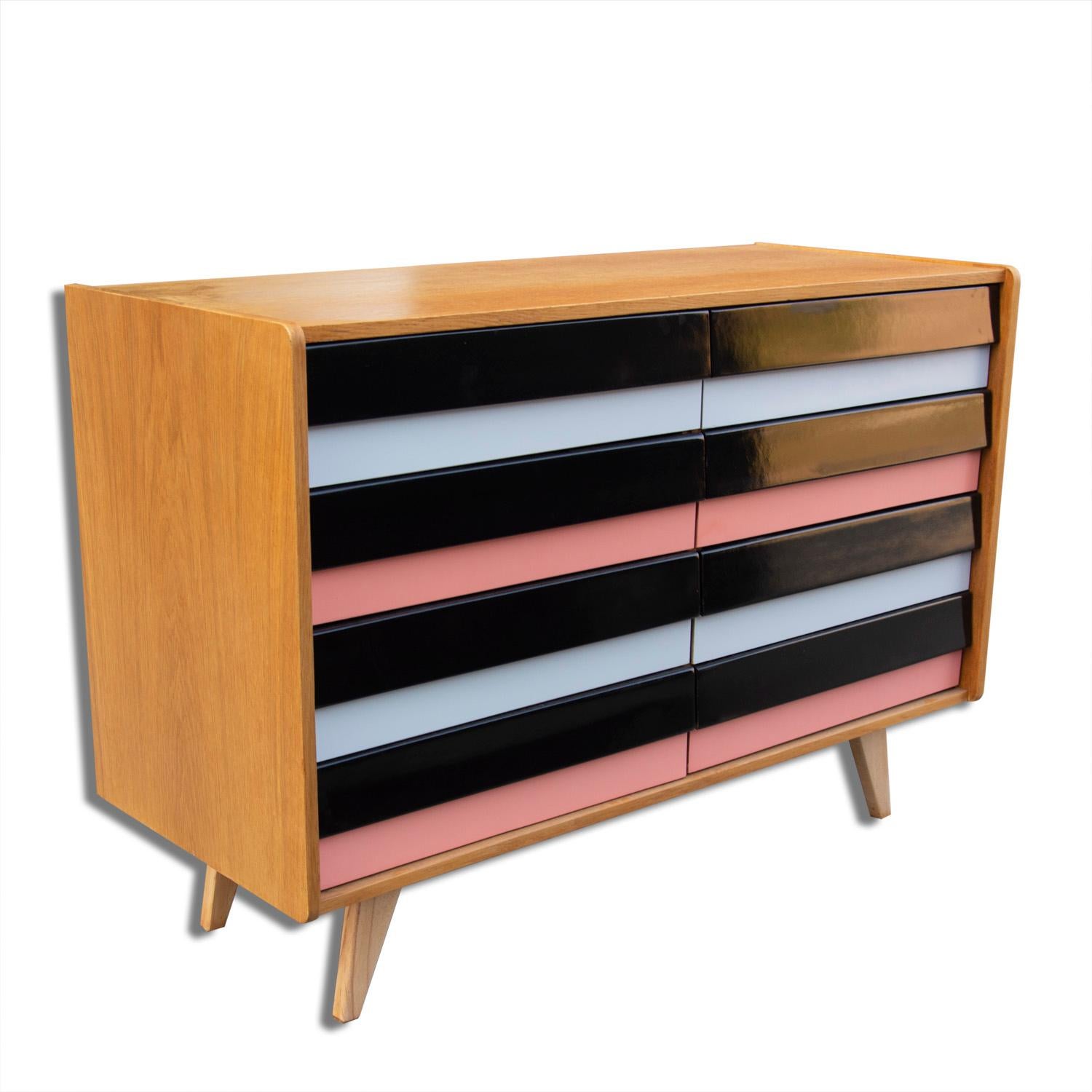 This beech and plywood chest of drawers, model U-458, was designed by Jirí Jiroutek and produced by Interier Praha during the 1960s. This model is associated with the world-renowned Brussels Period Expo 58 and features eight colored drawers. The