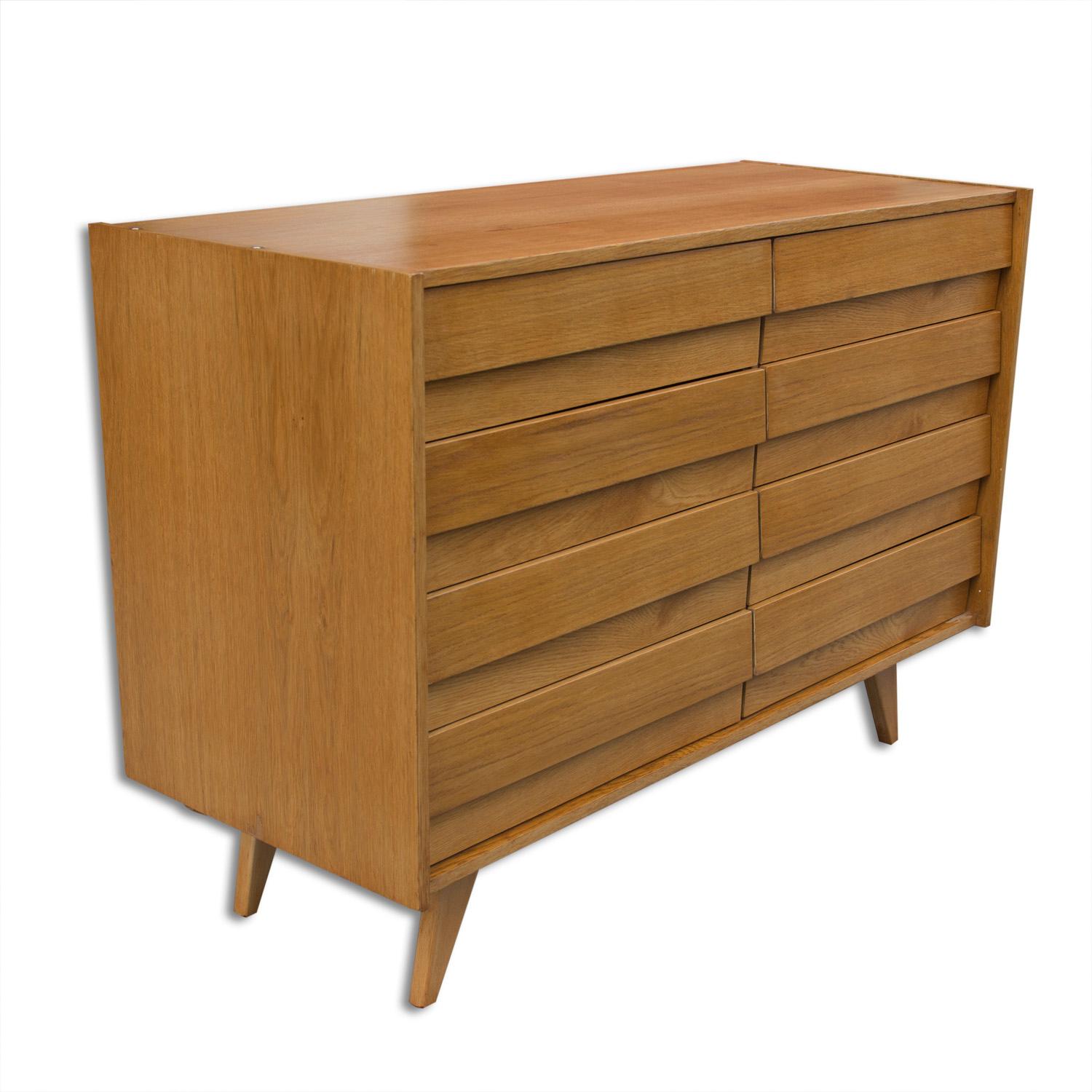 This beech and plywood sideboard, model U-458, was designed by Jirí Jiroutek and produced by Interier Praha during the 1960s. This model is associated with the world-renowned Brussels period Expo 58 and features eight drawers. The unit is in