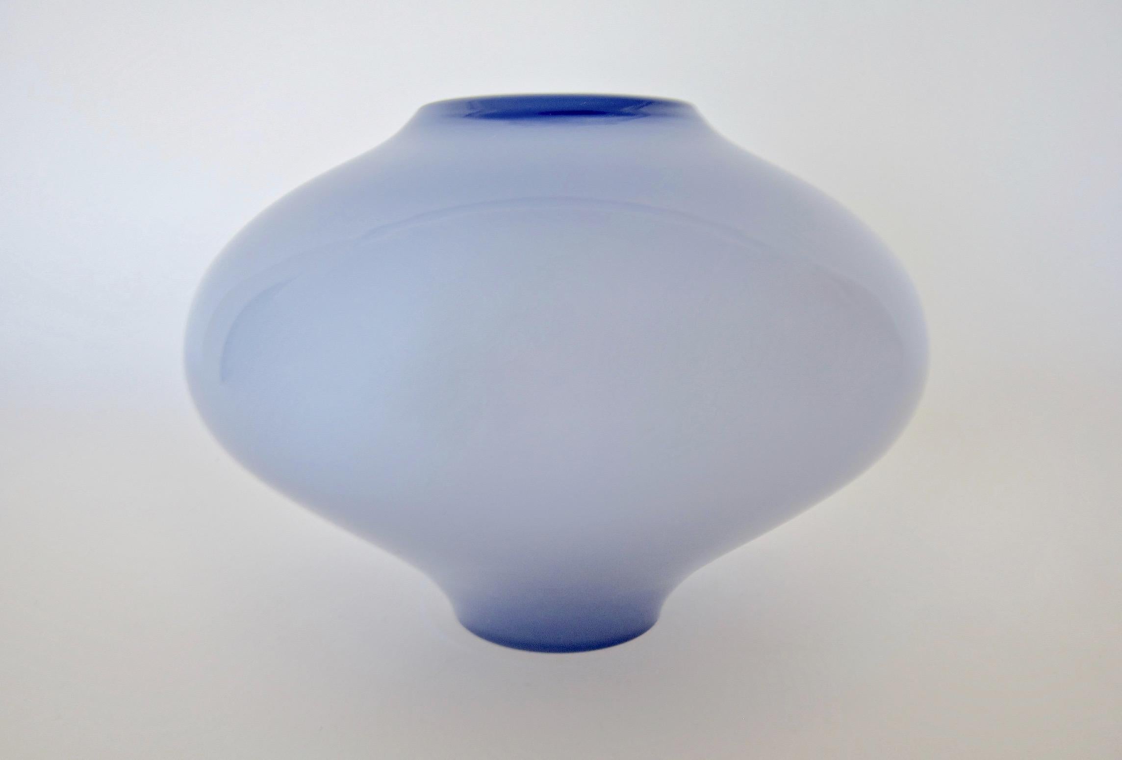 A vintage cased glass vase, blown into a retro shape resembling a UFO. The handcrafted vessel has a layer of lavender glass over a contrasting crisp, bright white interior. The vase is unmarked but likely the work of Carlo Moretti of Murano, Italy.