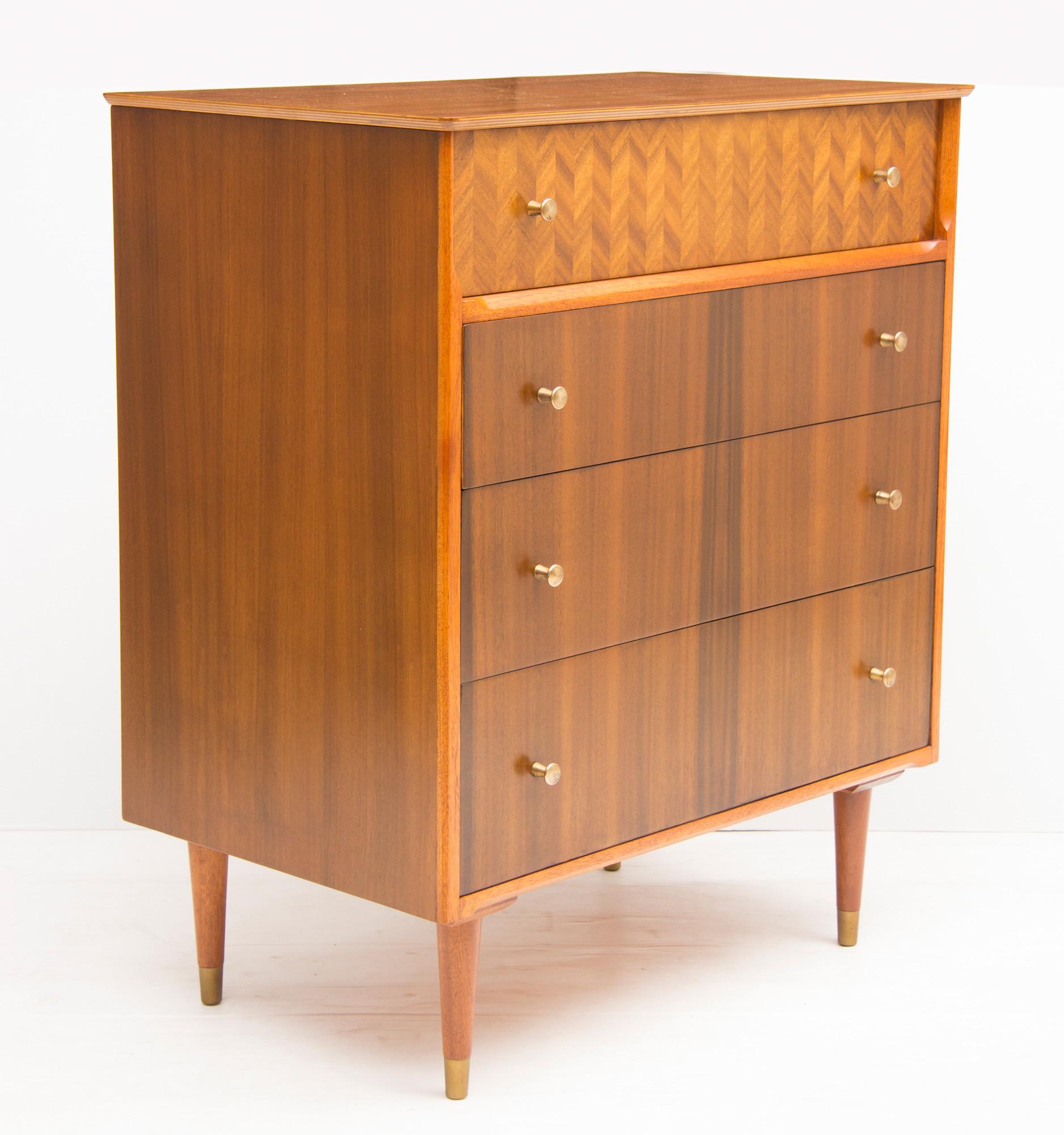 Midcentury walnut chest of drawers by Uniflex.
Midcentury chest of four drawers with brass knob handles
Top drawer has parquetry style veneer
Tapered legs with brass feet tips
Measures: H 93 cm, W 79 cm, D 47 cm
British, circa 1950.