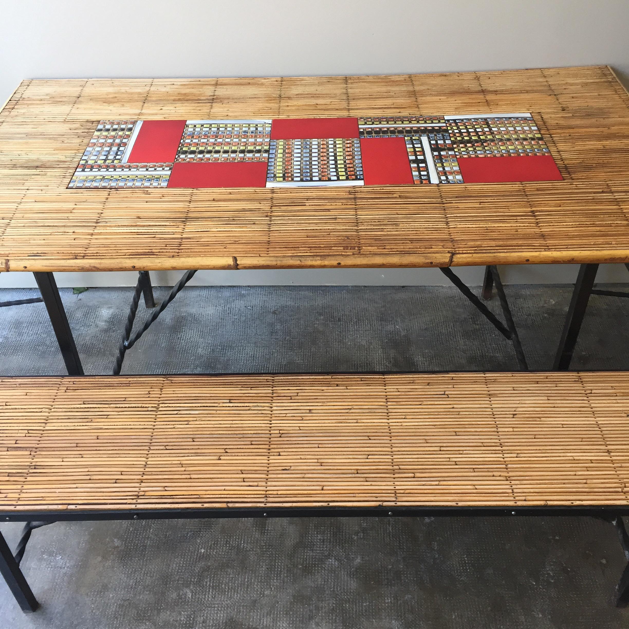 Midcentury, Vallauris bamboo Capron dining table set with 2 chairs and 1 bench.
Coming from a Vallauris workshop. (South of France)
Made of bamboo, patinated iron and ceramic tiles from Roger Capron at the center of the table.
12 tiles.
The seat