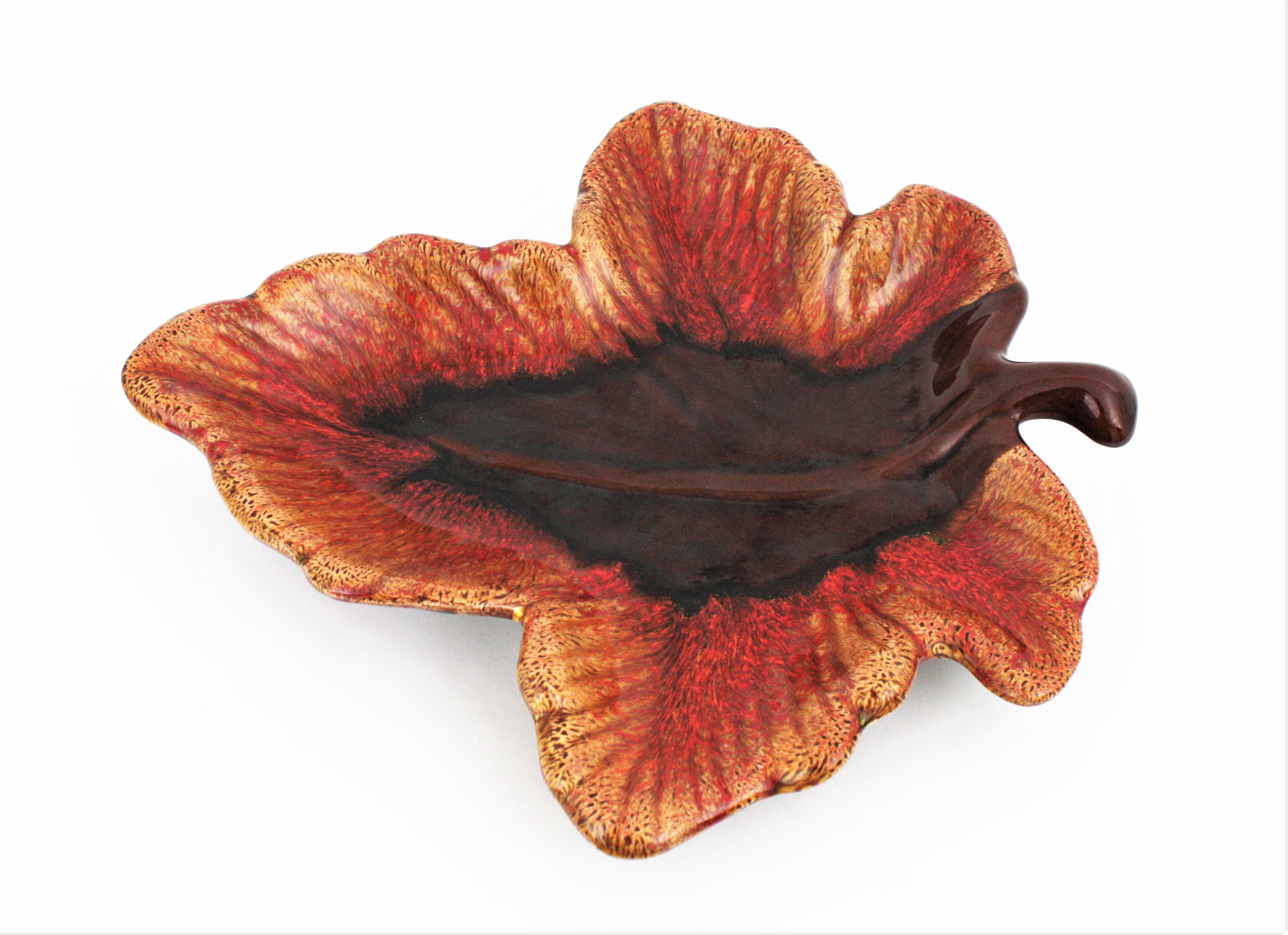 Impressive and colorful extra large leaf shaped glazed ceramic platter, serving tray or centerpiece manufactured by Vallauris. France, 1950-1960s.
Interesting to be used as centerpiece, fruit platter or cakes platter or serving tray. Its large