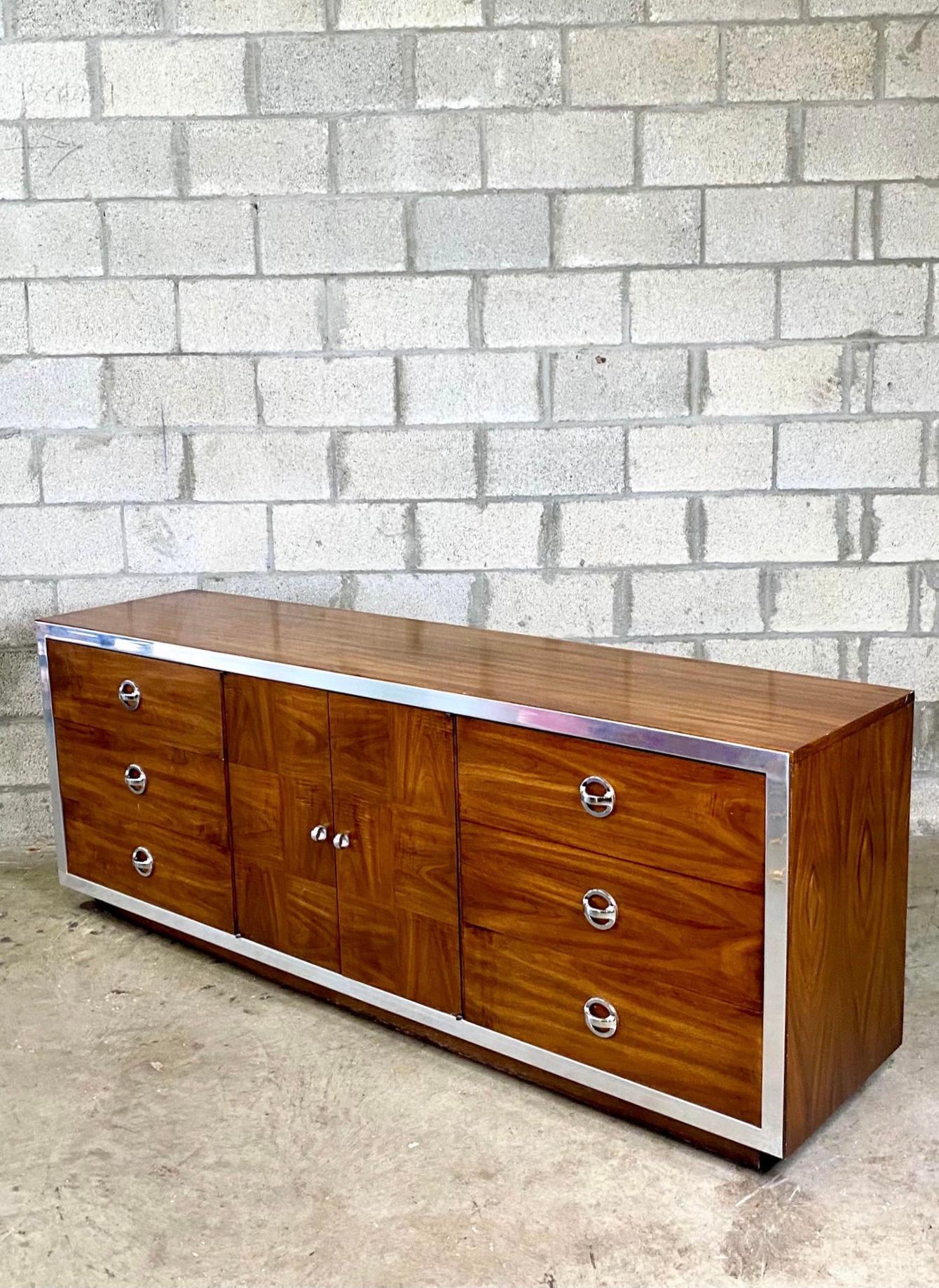 Fantastic midcentury VanLeigh dresser. Stunning wood grain detail with polished chrome trim. Parquet double doors reveal and an additional three drawers for 9 drawers total. Acquired from a Miami estate.